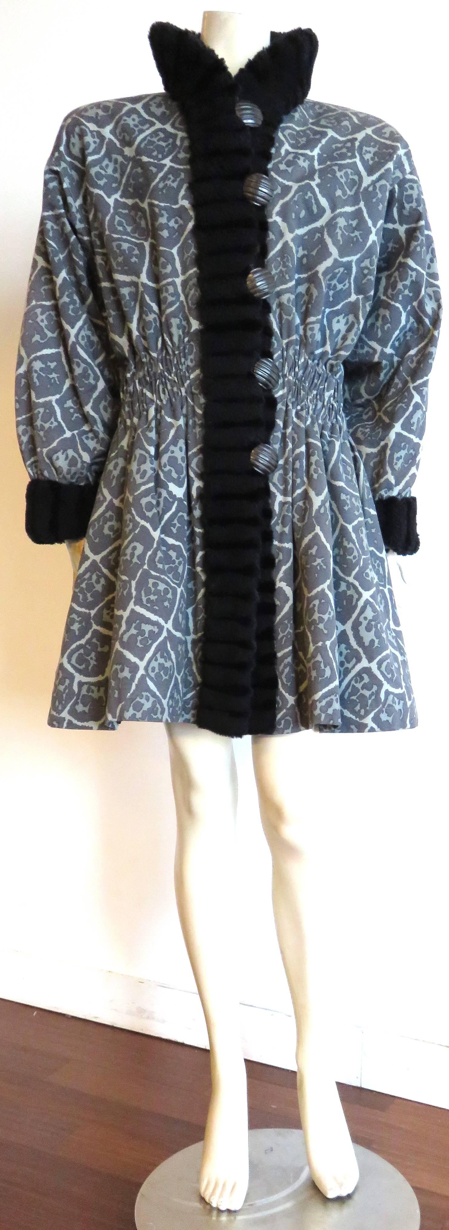 Fabulous, 1980's, YVES SAINT LAURENT FURS printed coat with shearling, and beaver fur trim.

This amazing coat features all-over, animal-style print in gray-scale color-way onto woven, ottoman fabric.

Black shearling, and beaver fur collar,