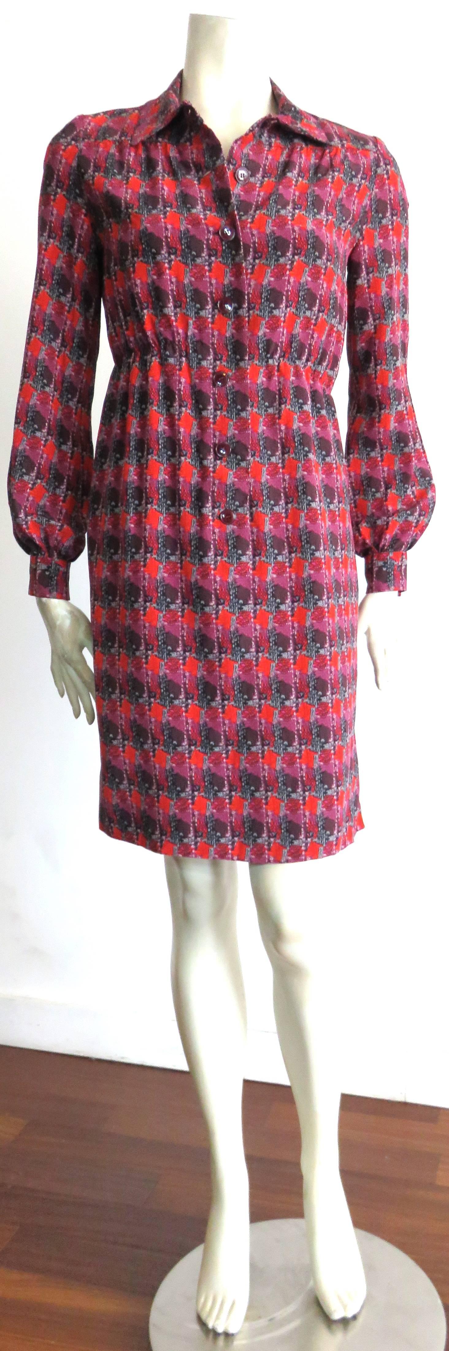 Excellent condition, 1970's YVES SAINT LAURENT Printed silk dress in vibrant shades of red, burgundy, night blue, and light gray.  

Button front placket with elasticated waist-line.

Fully lined.

*MEASUREMENTS*

There is no size label