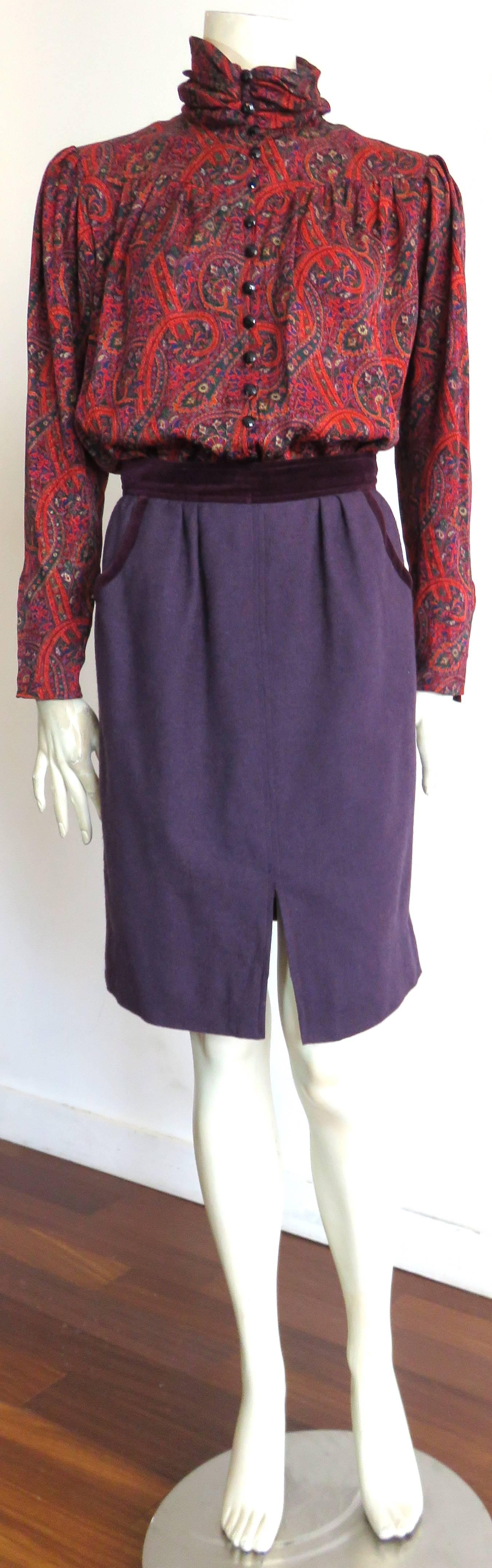 Excellent condition, 1980's UNGARO PARIS 3pc. skirt suit set.

This complete set includes, aubergine, wool knit, shirt-style jacket, matching skirt, and neck-tie, as well as paisley printed, silk blouse.  

The shirt-style jacket features