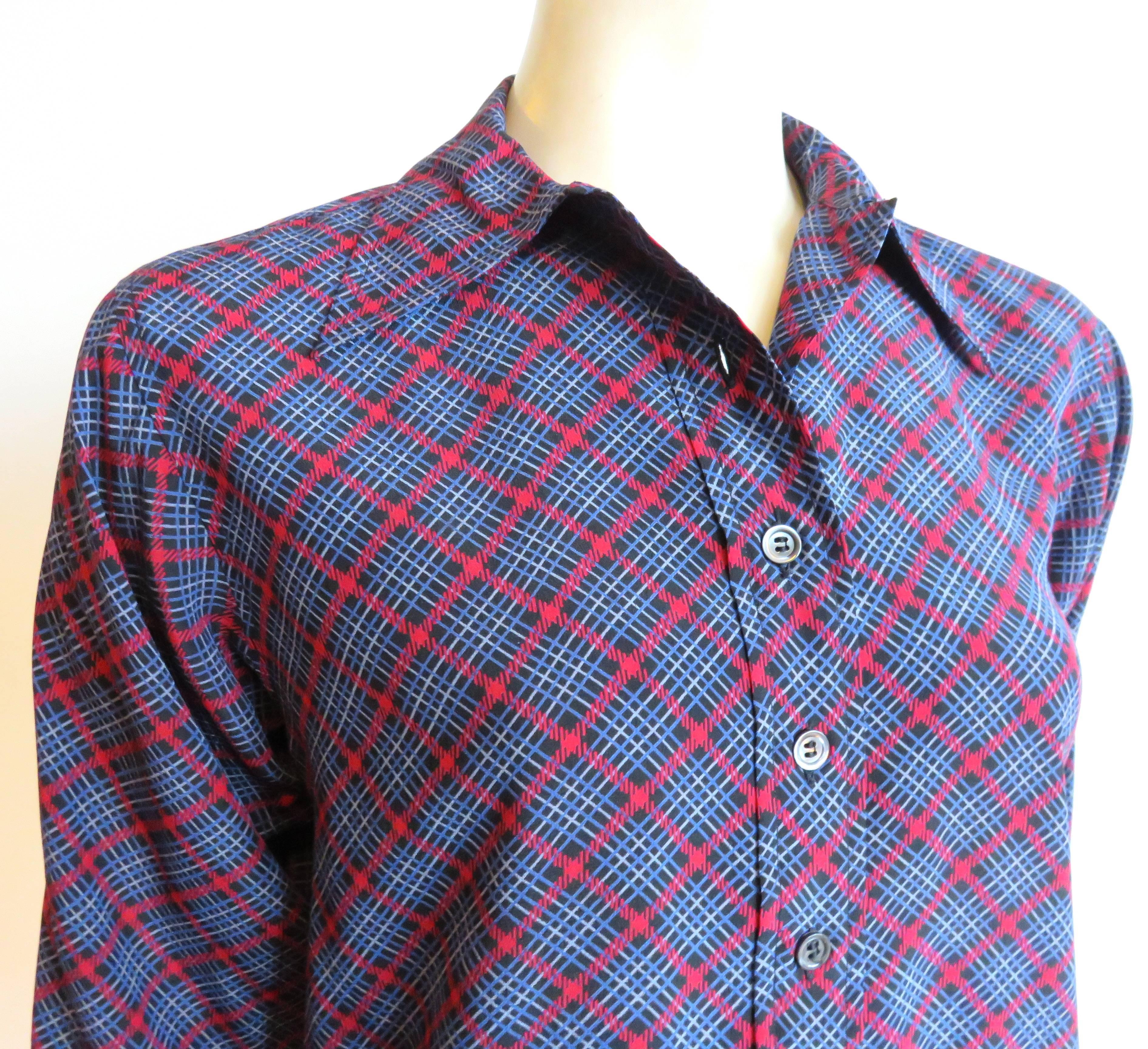 Excellent condition, 1970's YVES SAINT LAURENT Plaid silk blouse top.

Button-down front placket and cuffs.

Made in France, as labeled.

*MEASUREMENTS*

Flat underarm to underarm: 18