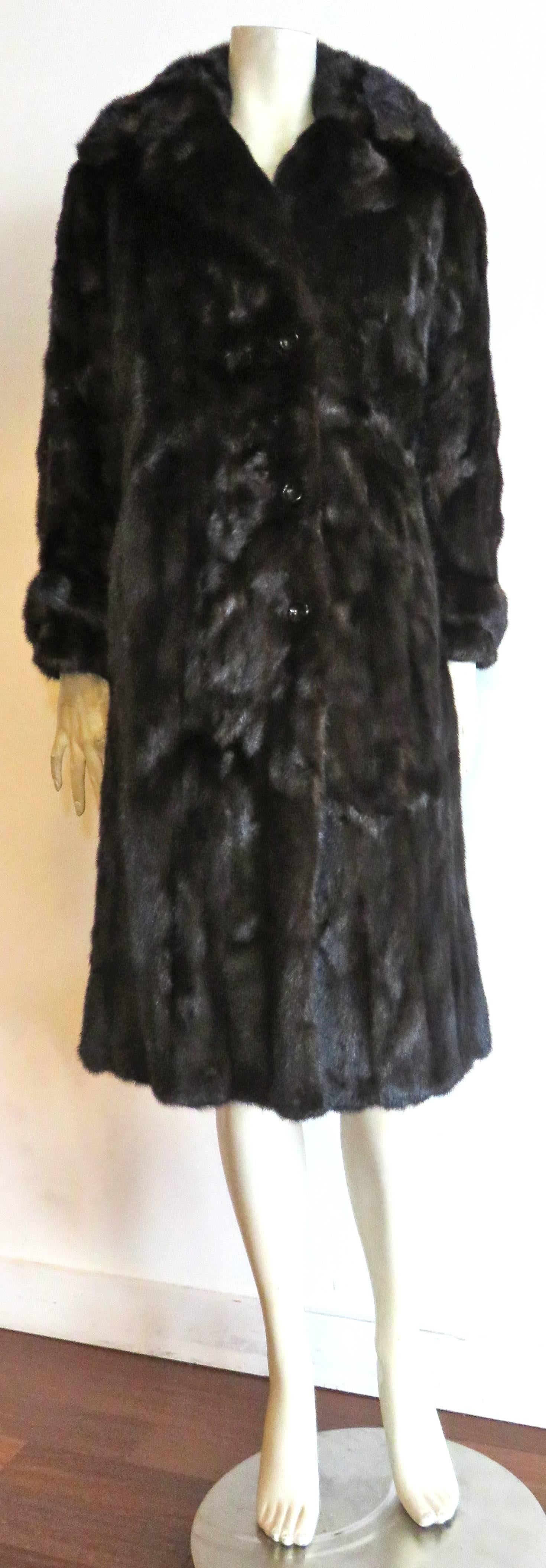Mint condition, 1960's MINK  FUR COAT.

This genuine, luxurious, dark brown, mink coat looks to have never been worn, and is absolutely stunning.

Slick, polished mink fur with absolutely no flaws.

Fully lined in dark brown silk taffeta with