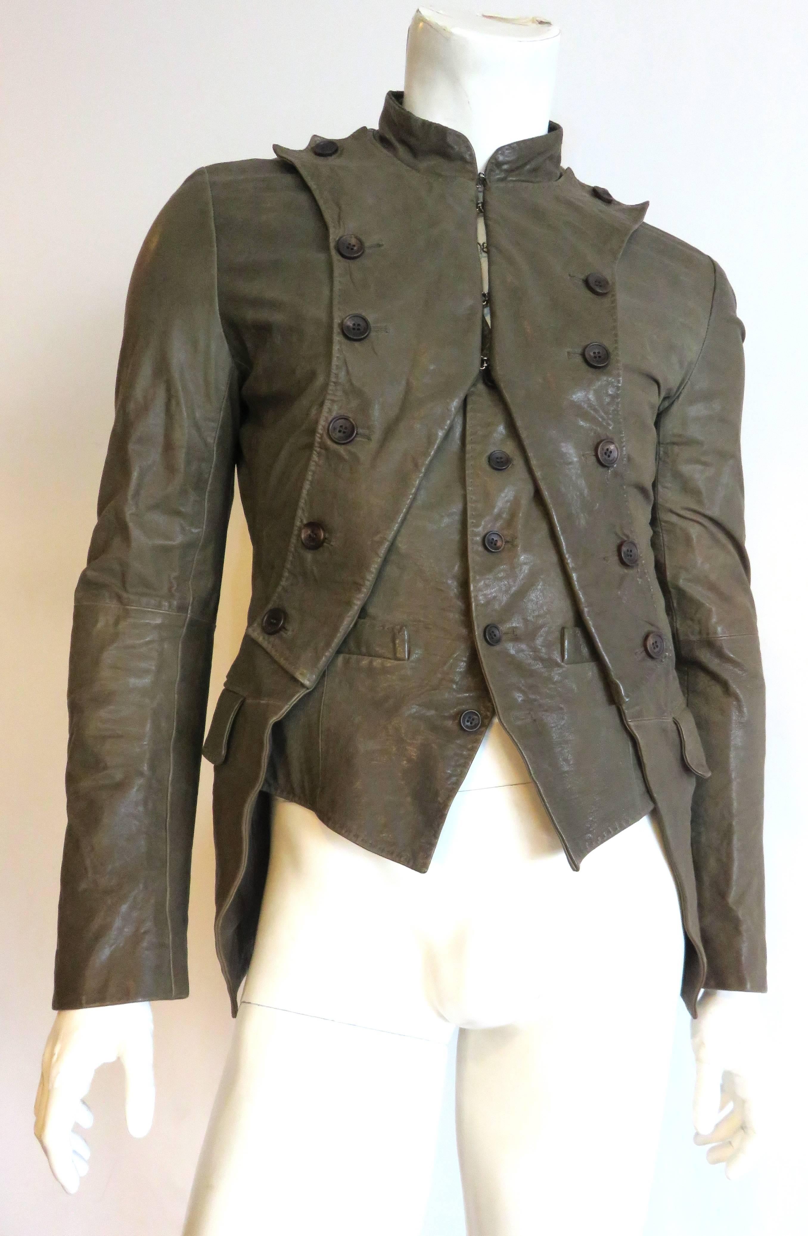 Worn once, excellent condition, JOHN GALLIANO, men's calfskin leather french infantry-style jacket.

Amazing, olive green, double-layered jacket inspired by the french infantry uniforms of the early 1800's.  

Top layer jacket features curved,