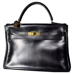 HERMÈS BLACK CALF BOX LEATHER RETOURNÉ KELLY 32 WITH GOLD PADLOCK and KEY, 1964