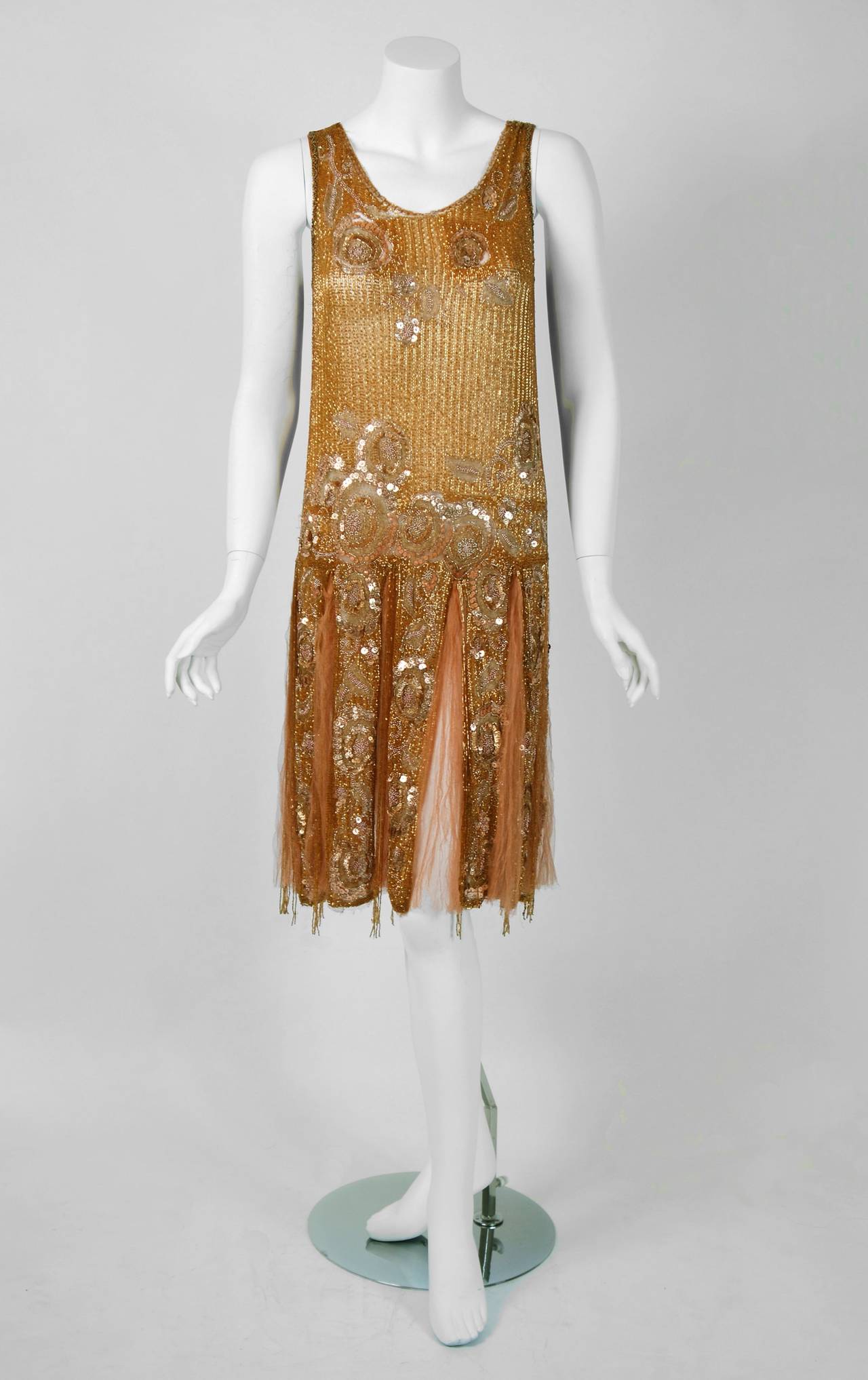 There are lots of lovely 1920's garments still around, but every once in a while I come across one that sets my heart a flutter! This is an extraordinarily beautiful and exceptional 1920's metallic gold couture silk-net dance dress and matching