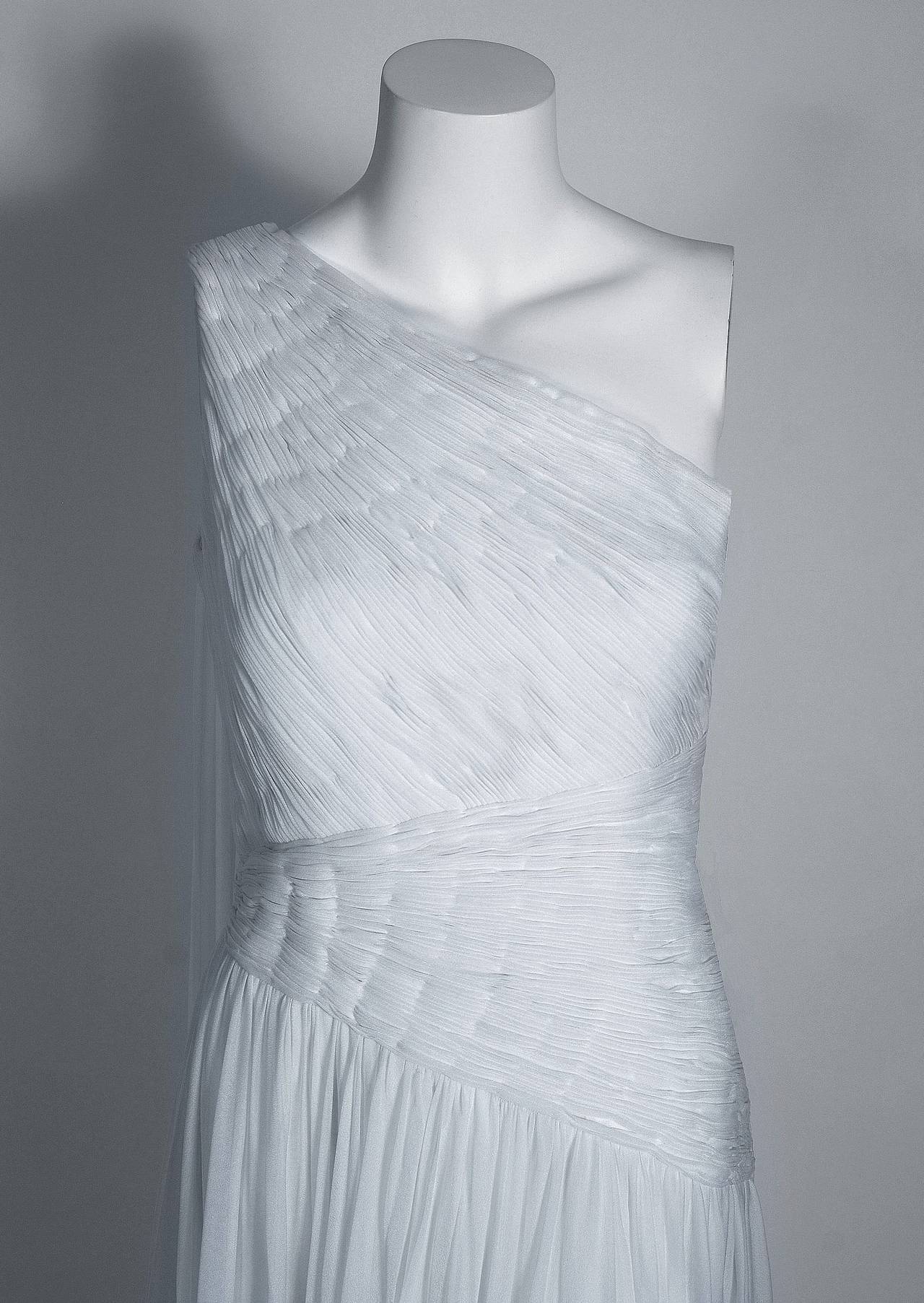 Ethereal crisp-white goddess gown from Parisian couturier Claude Riha. This stunning chiffon dress has so much detail, you can tell it was made with loving devotion. The bodice is hand-pleated and hand-stitched into place with a beautiful back