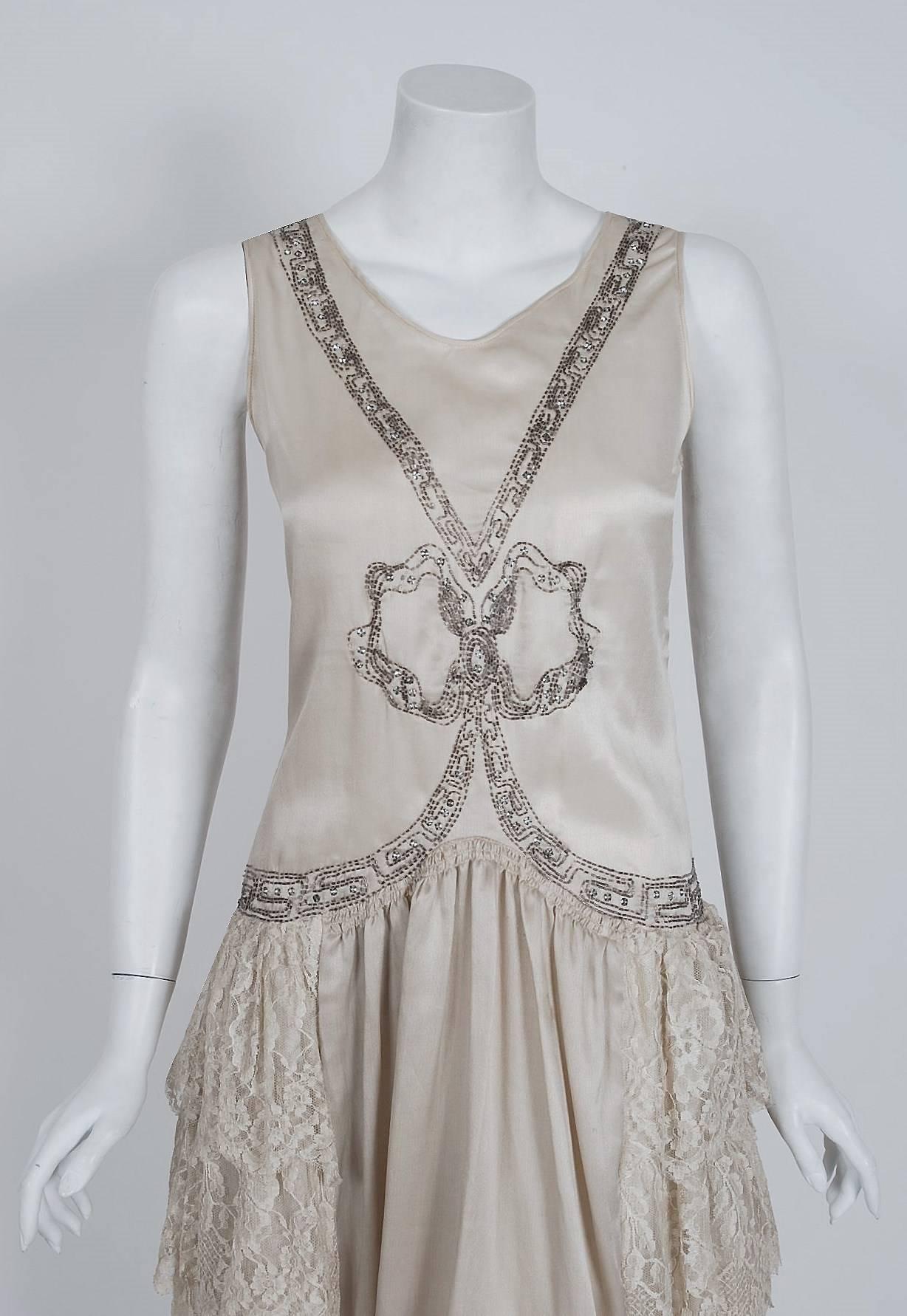 Romantic flapper dresses from the early 20th century are perennial favorites and this one is a show-stopper. The garment's simple unstructured style is so modern; the fine beadwork and mixed textiles are a treasure trove of needle art. This beauty,
