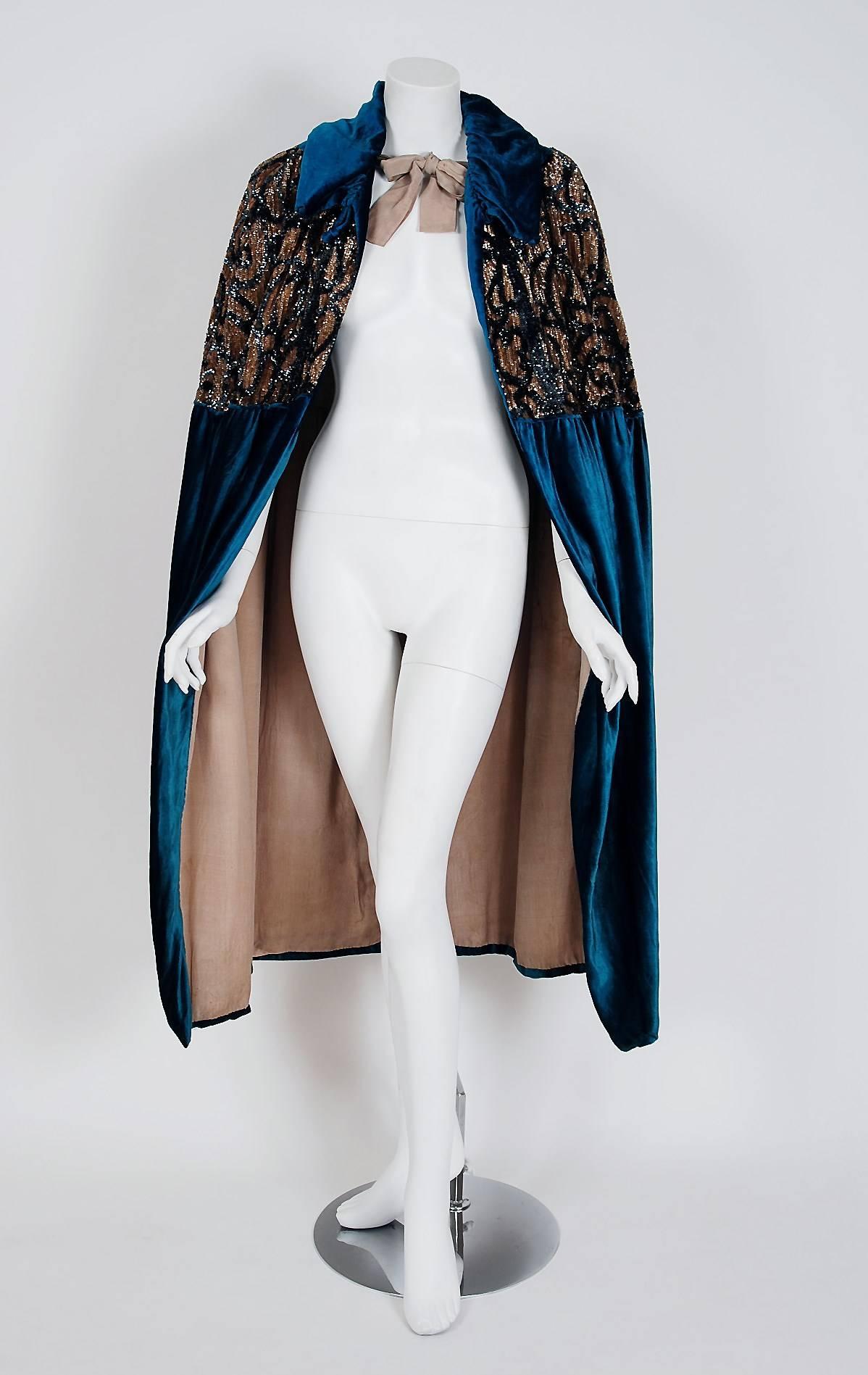 This is a 1920's couture masterpiece from J.L. Hudson which was a very popular high-end Detroit department store. Evening capes from the Art-Deco era remain a perennial favorite, perhaps because no other period combined such opulence with youthful