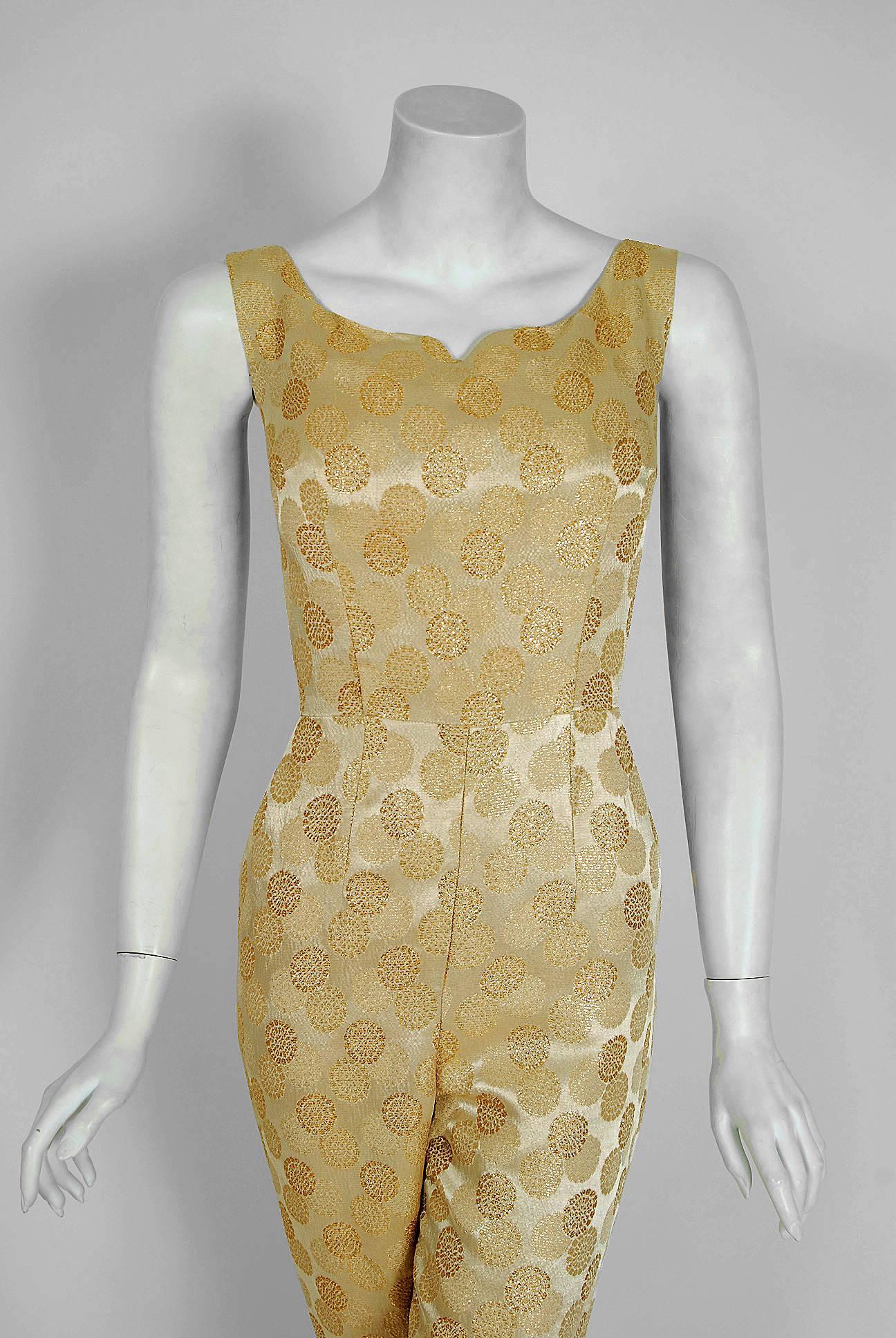 Words can not describe how beautiful this 1950's Bullock's Wilshire jumpsuit ensemble is! It's fashioned from fully-lined metallic gold atomic patterned silk-lame brocade. It is cut in that classic pin-up bombshell style; all curves and sexiness.