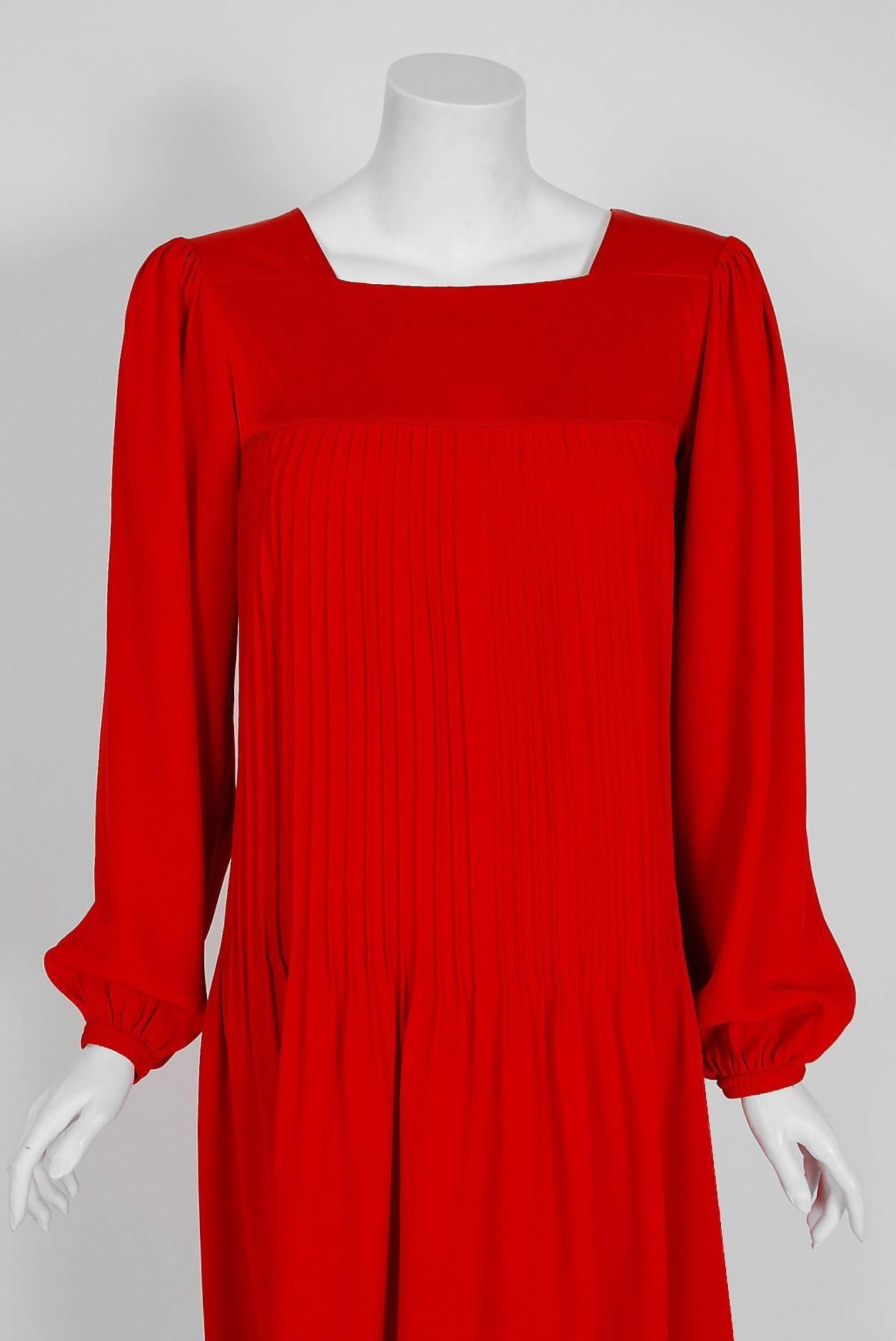 Breathtaking Yves Saint Laurent ruby-red crepe and satin dress from the infamous Rive Gauche collection during the mid-1970's. Pieces from this decade are very rare and are true examples of fashion history. I adore the square-neck heavily pleated