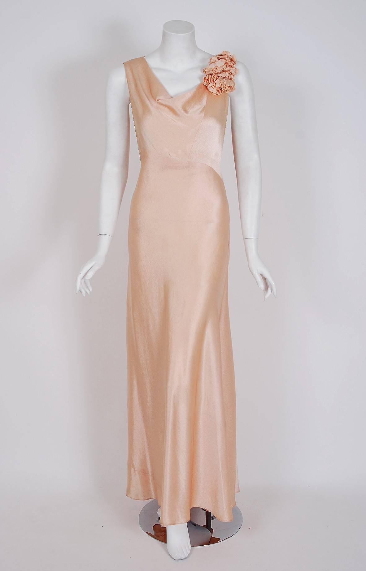 The breathtaking champagne-pink textured silk satin fabric used for this custom couture 1930's French dress ensemble has an ethereal quality that I find irresistible! The bodice has an elegant draped-cowl neckline and unique 3-dimensional floral