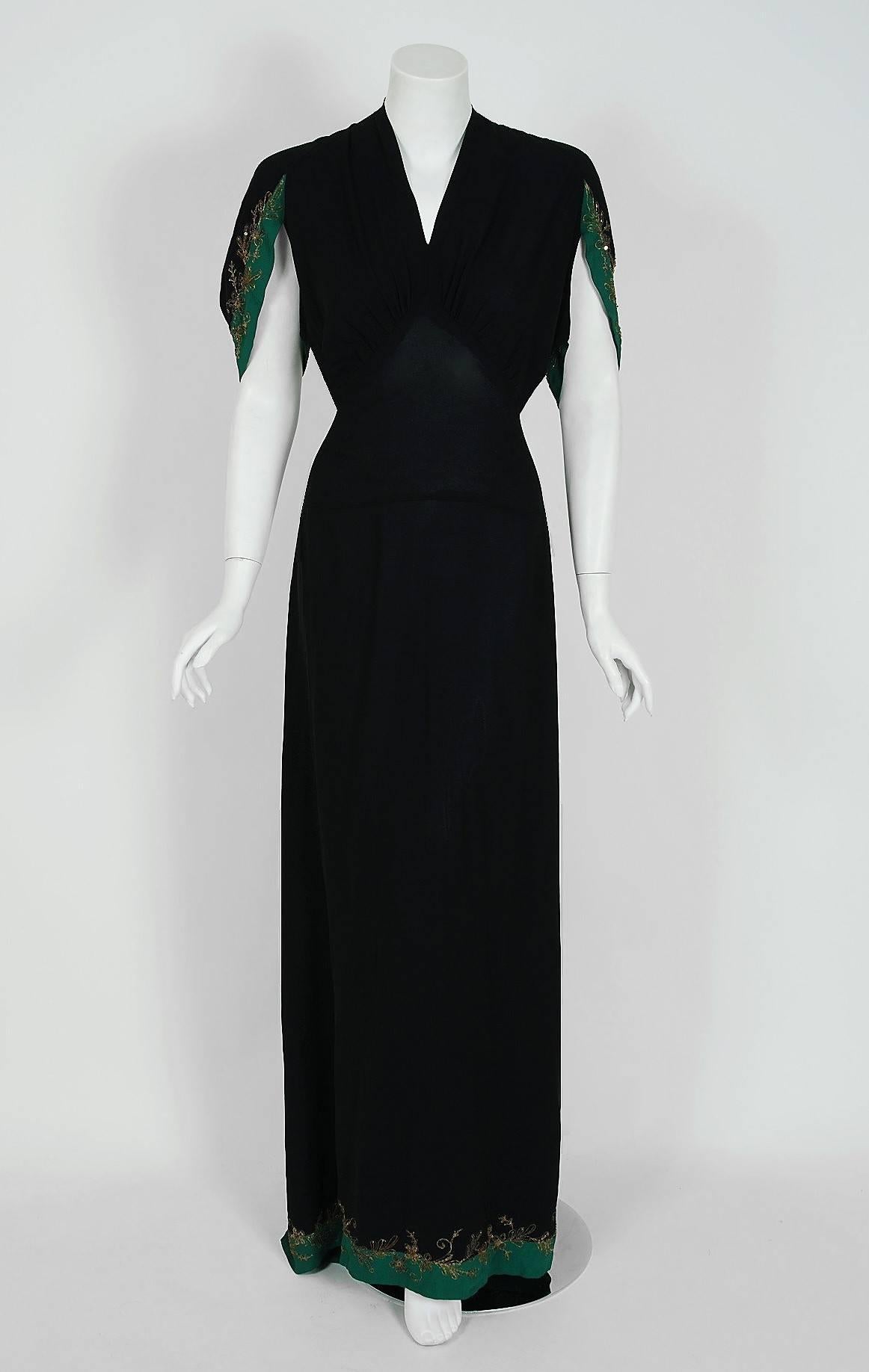 A breathtaking 1930's black and teal metallic embroidered sequin silk-rayon gown from the Old Hollywood era of glamour! The bodice is a seductive bias-cut gathered plunge with built-in sash belt. I adore the winged-sleeves which add the perfect