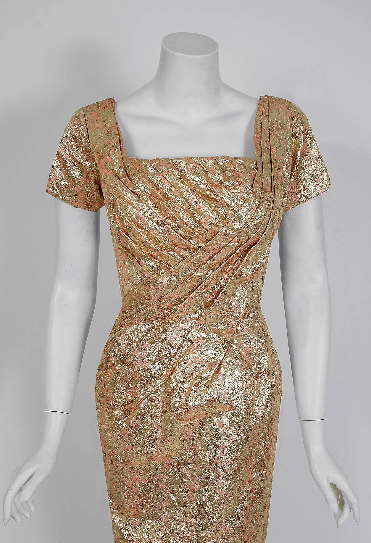 This is such a seductive and dramatic cocktail dress from the iconic Ceil Chapman designer label. Perfect for any upcoming party; you can't help but feel feminine in this beauty! The garment is fashioned from a stunning metallic gold floral