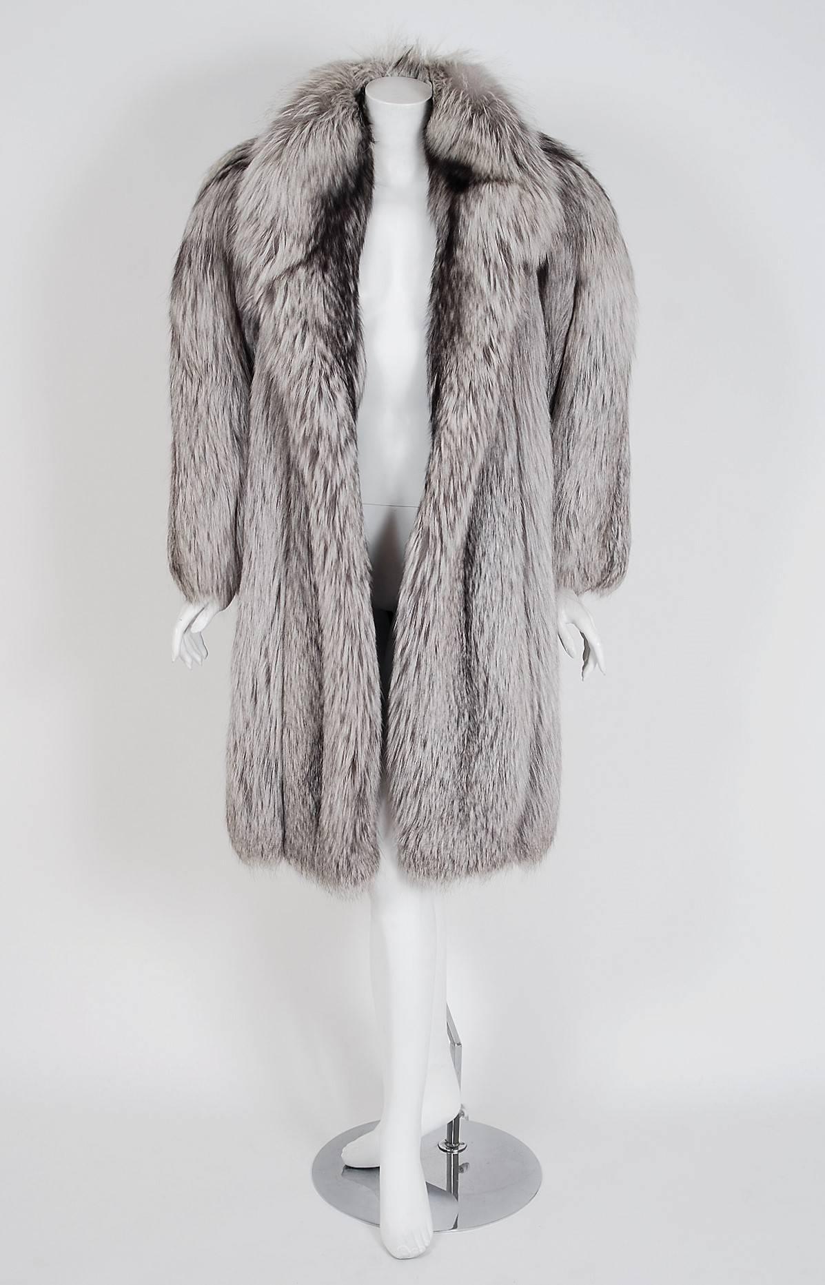 Breathtaking Yves Saint Laurent Fourrures genuine silver-fox coat from his 1971 Fall/Winter collection. Such a rarity to find in such pristine condition! It is insanely chic with its easy-to-wear style yet dramatic silhouette. The level of quality