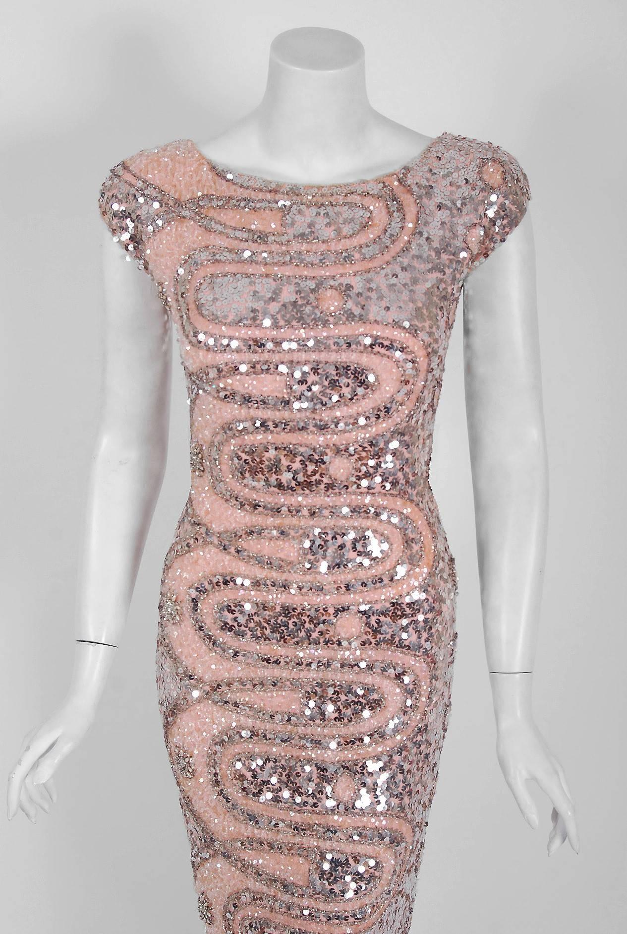1950's Gene Shelly designer garments are in a class of their own. They are always fully-sequined by hand and fit to flatter the figure. This treasure has a fantastic abstract atomic swirl pattern, featuring silver glass-beads. The base is a soft