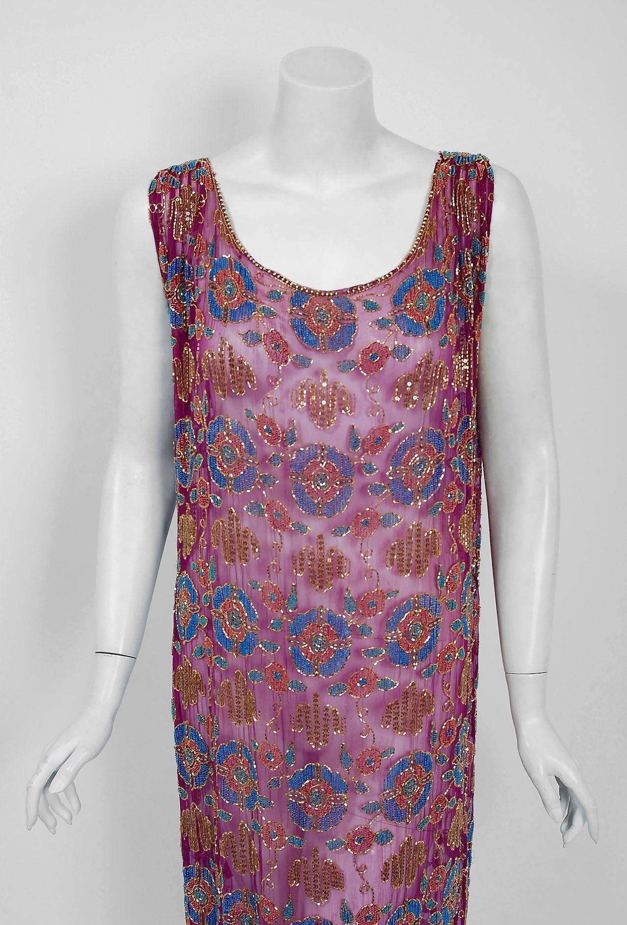 Romantic flapper dresses from the early 20th century are perennial favorites and this one is a show-stopper. The garment's simple unstructured style is so modern yet the fine couture beadwork is a treasure trove of needle art. The beading, made up