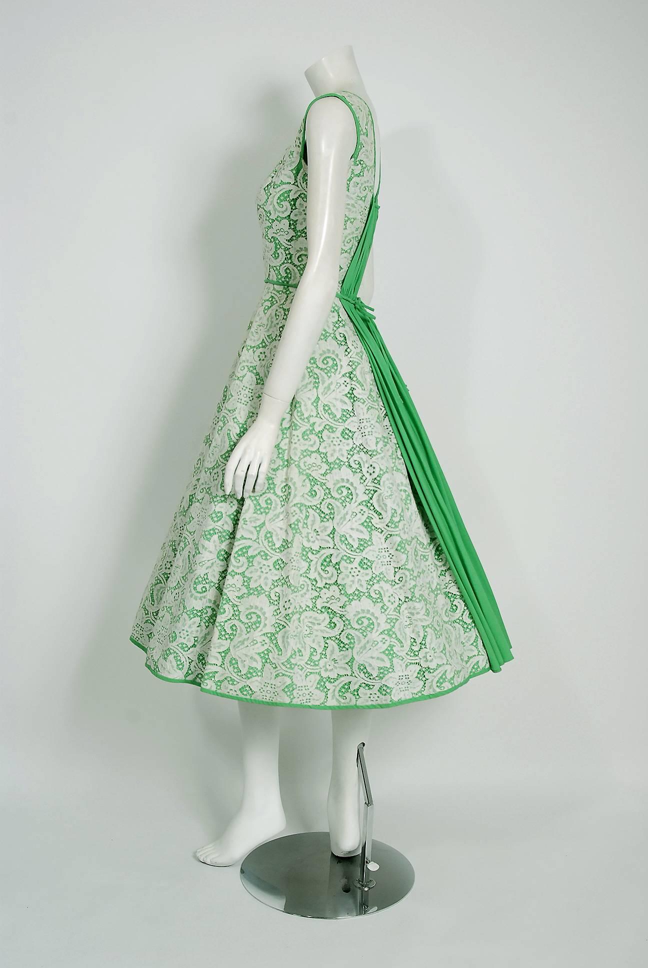 In this gorgeous 1950's Pat Premo designer sundress, the unique detailed construction and meticulous attention to detail are comparable to what you will find in modern couture. This enchanting garment is fashioned from seafoam green polished cotton
