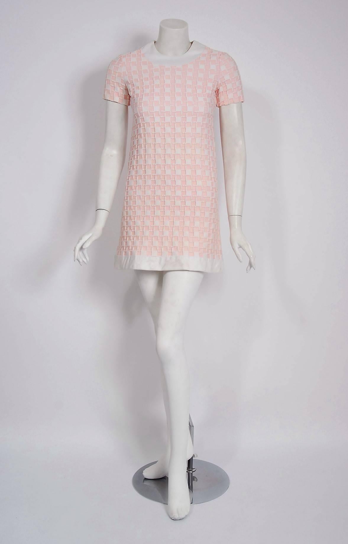 Magnificent Pierre Cardin mod dress in an elegant pink and white color combination from his iconic 1966 documented collection. In 1951 Cardin opened his own couture house and by 1957, he started a ready-to-wear line; a bold move for a French
