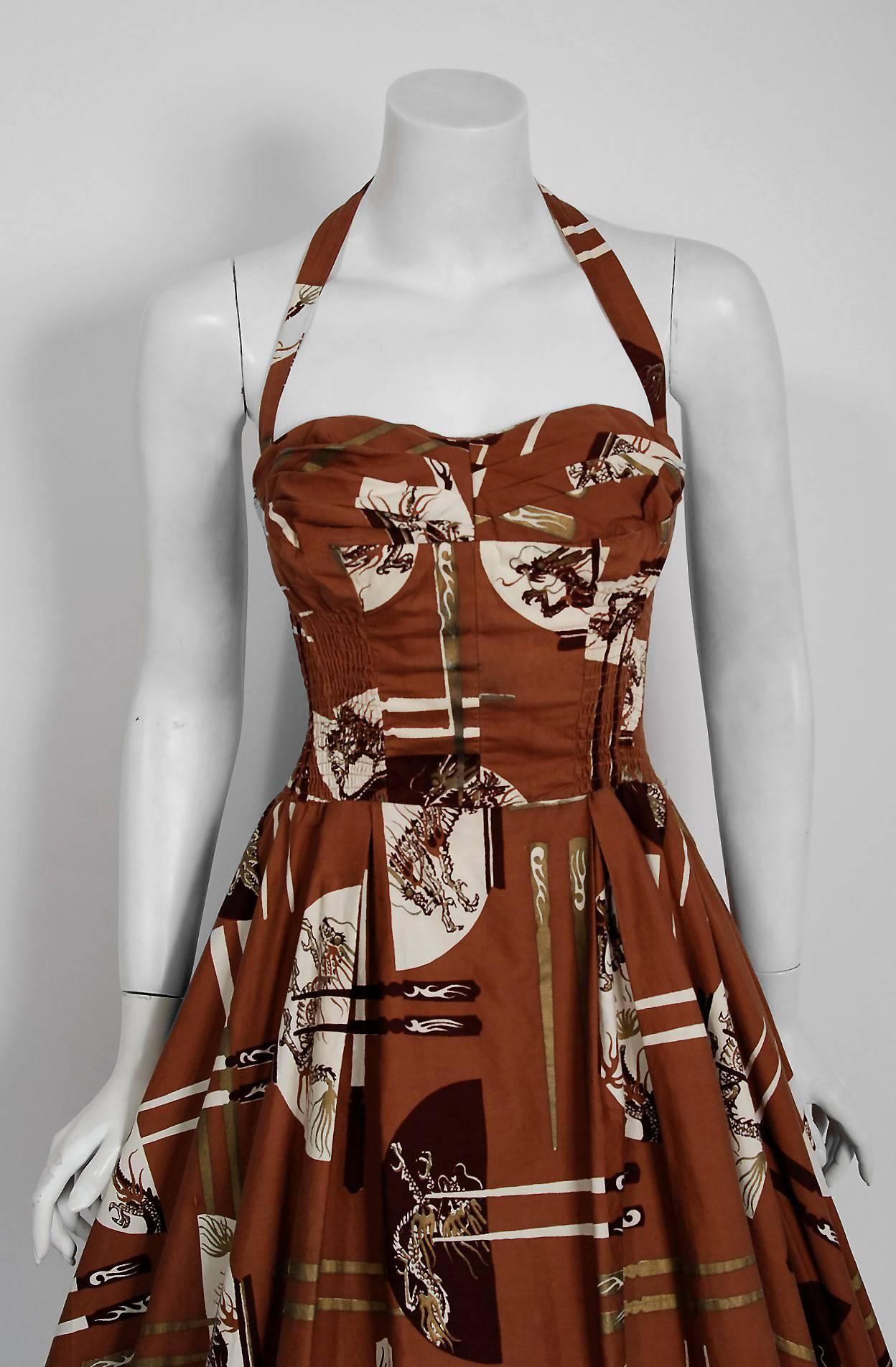 With its vivid cotton novelty and flawless styling, this Alfred Shaheen designer sundress has the casual elegance the 1950's were known for. The print is unbelievable; large scale Chinese dragons with incredible iridescent shimmer. I adore the