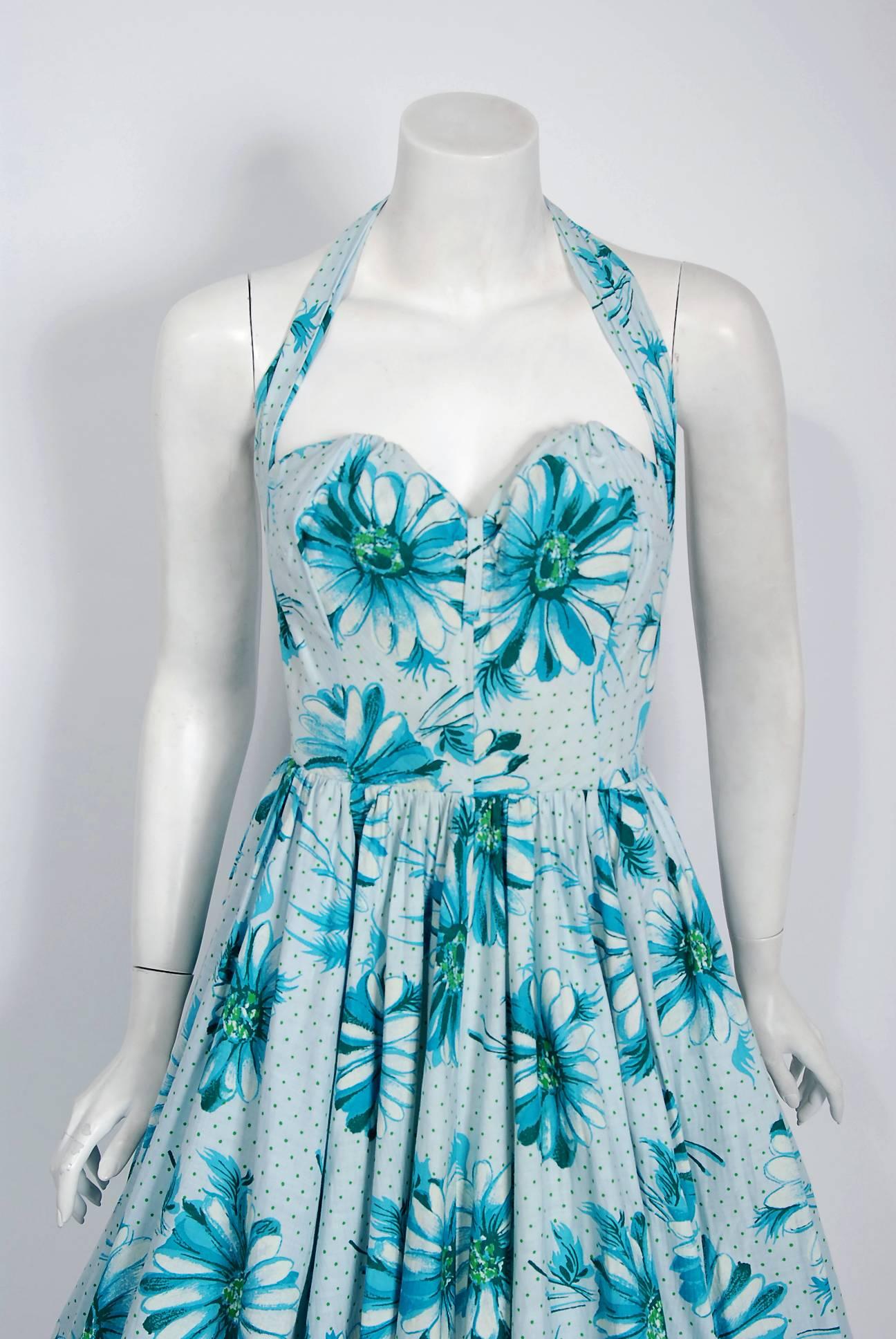 In this gorgeous 1950's Herman Original Florida designer sundress, the unique detailed construction and meticulous attention to detail are comparable to what you will find in modern couture. This enchanting garment is fashioned from dotted blue