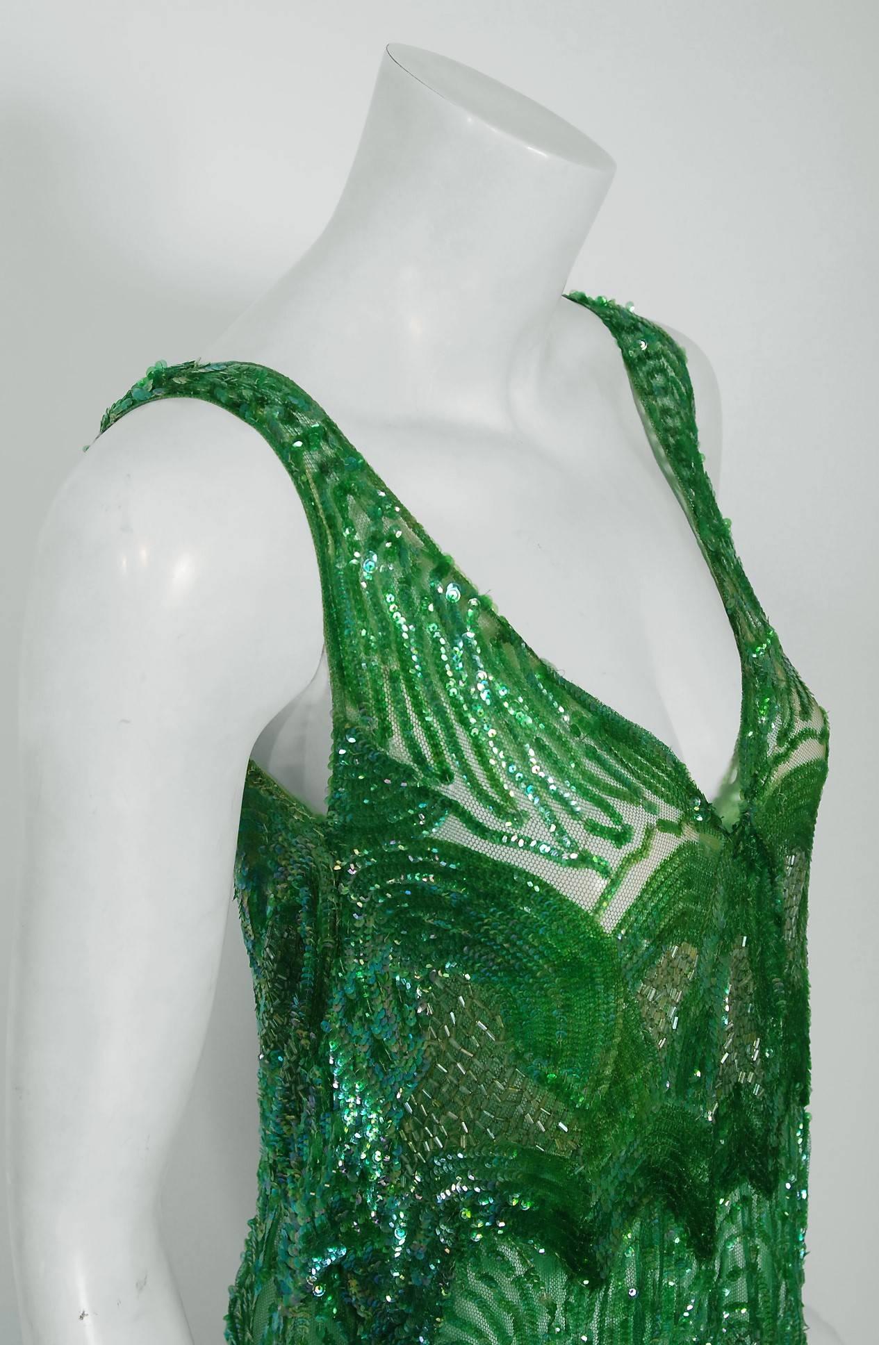 Breathtaking 1920's museum quality sparkling sheer-net flapper dance dress. The vibrant emerald green color palette touches a deep chord in our collective aesthetic consciousness. As fashion lovers, we never tire from antique beadwork; it will