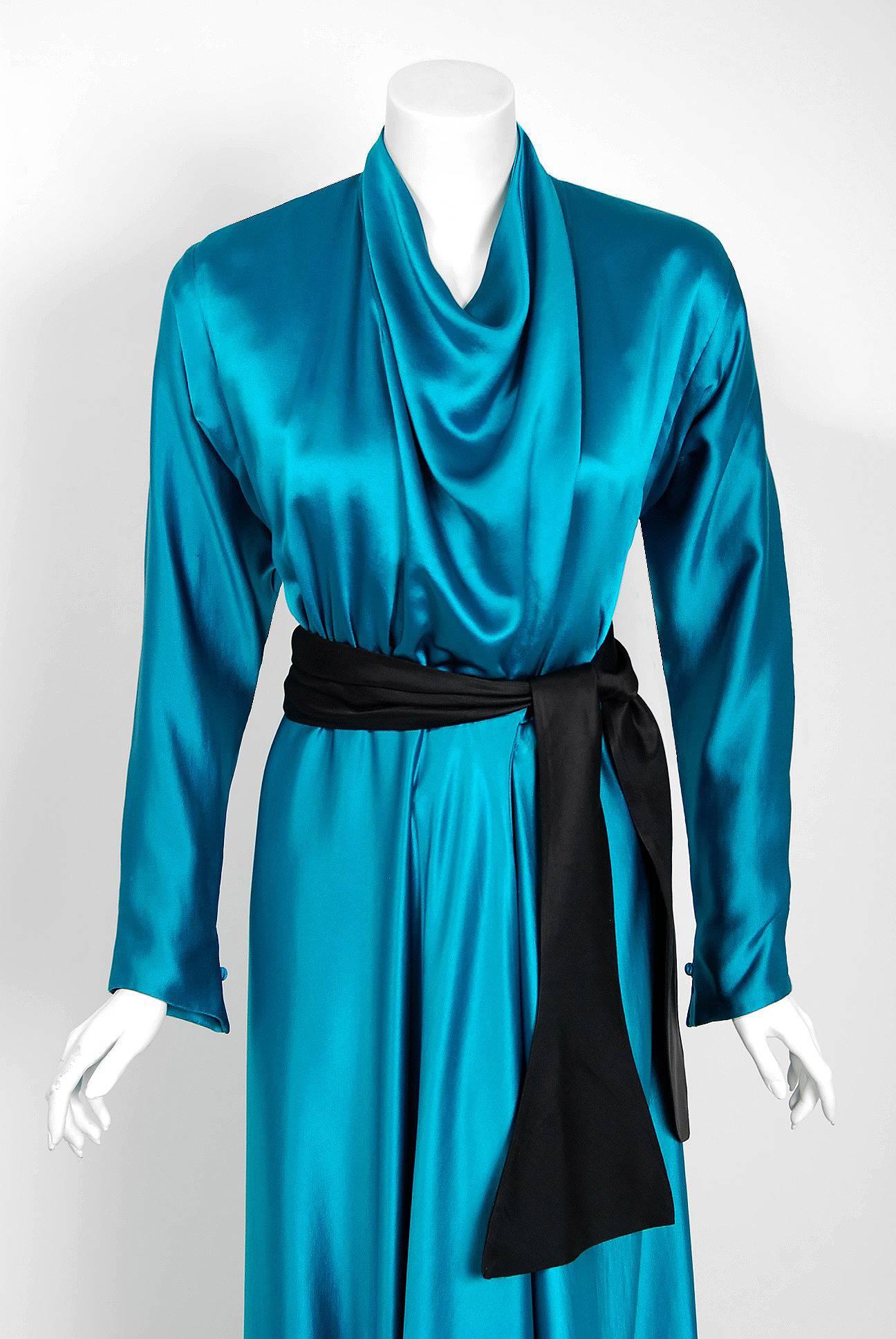 Gorgeous teal-blue Halston Couture belted wrap gown dating back to his 1978 collection. Throughout most of the seventies he epitomized the glamour, as well as the decadence of the era, becoming a central figure in the nightlife scene of New York's