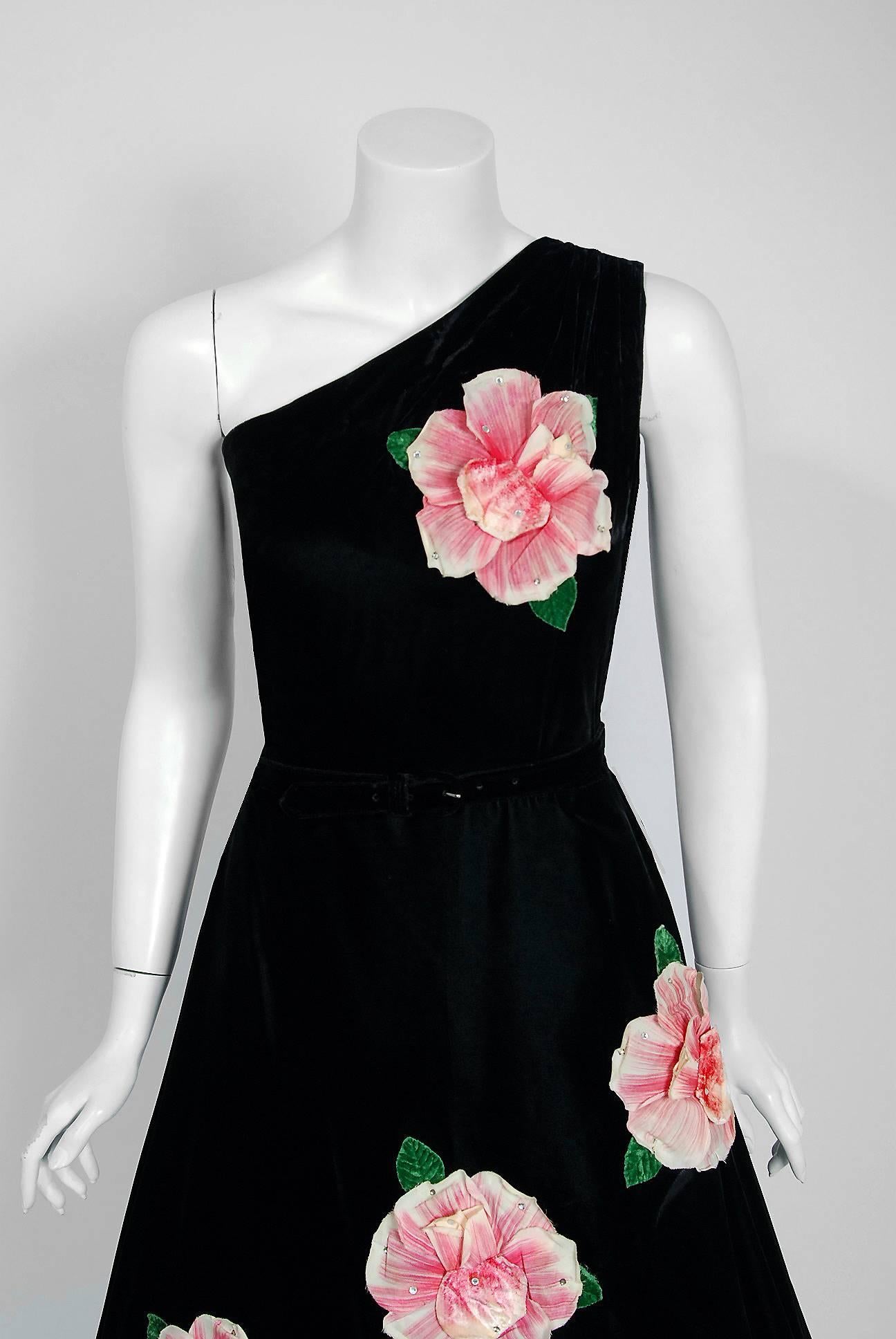 This is perhaps one of the most alluring and flattering little black dresses I have ever seen! Fashioned from soft silk-velvet, this creation has everything a woman wants. The bodice is an elegant asymmetric one-shoulder sleeveless design with