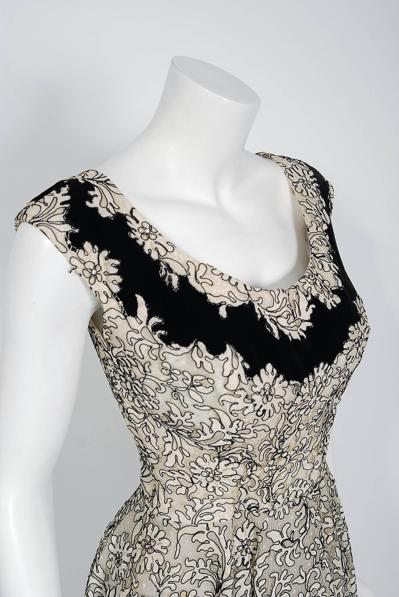 Breathtaking ivory and black corded illusion floral lace party dress created by Italian designer Fernando Sarmi when he was head designer for Elizabeth Arden in the 1950's. Sarmi developed a wonderful reputation as a top designer, wooing an