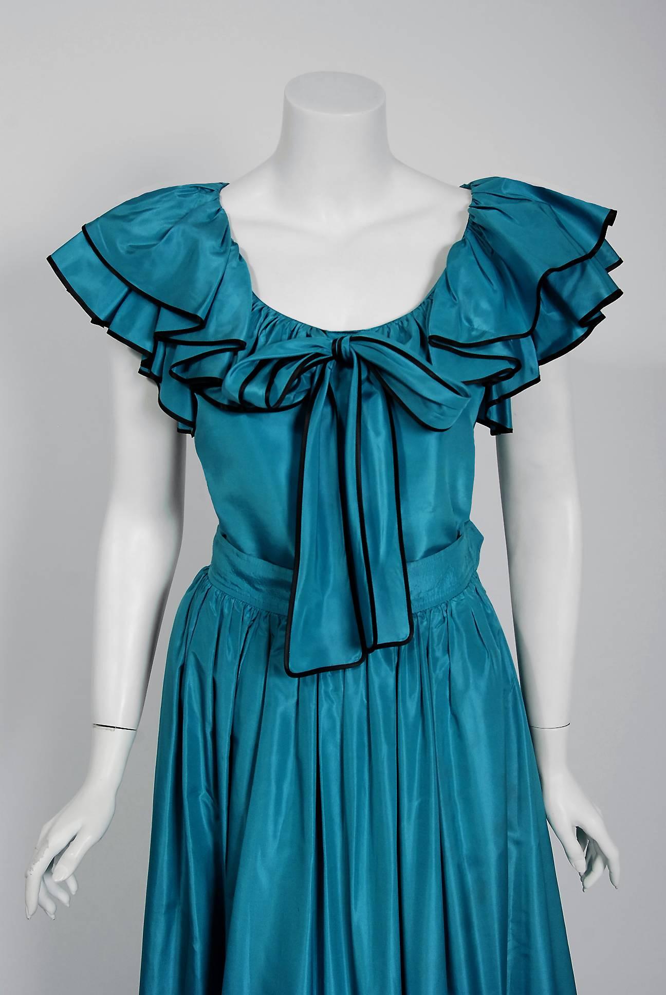 Romantic Yves Saint Laurent turquoise blue silk taffeta ensemble from the infamous Rive Gauche collection during the mid-1970's. Pieces from this decade are very rare and are true examples of fashion history. I adore the black pipping along the