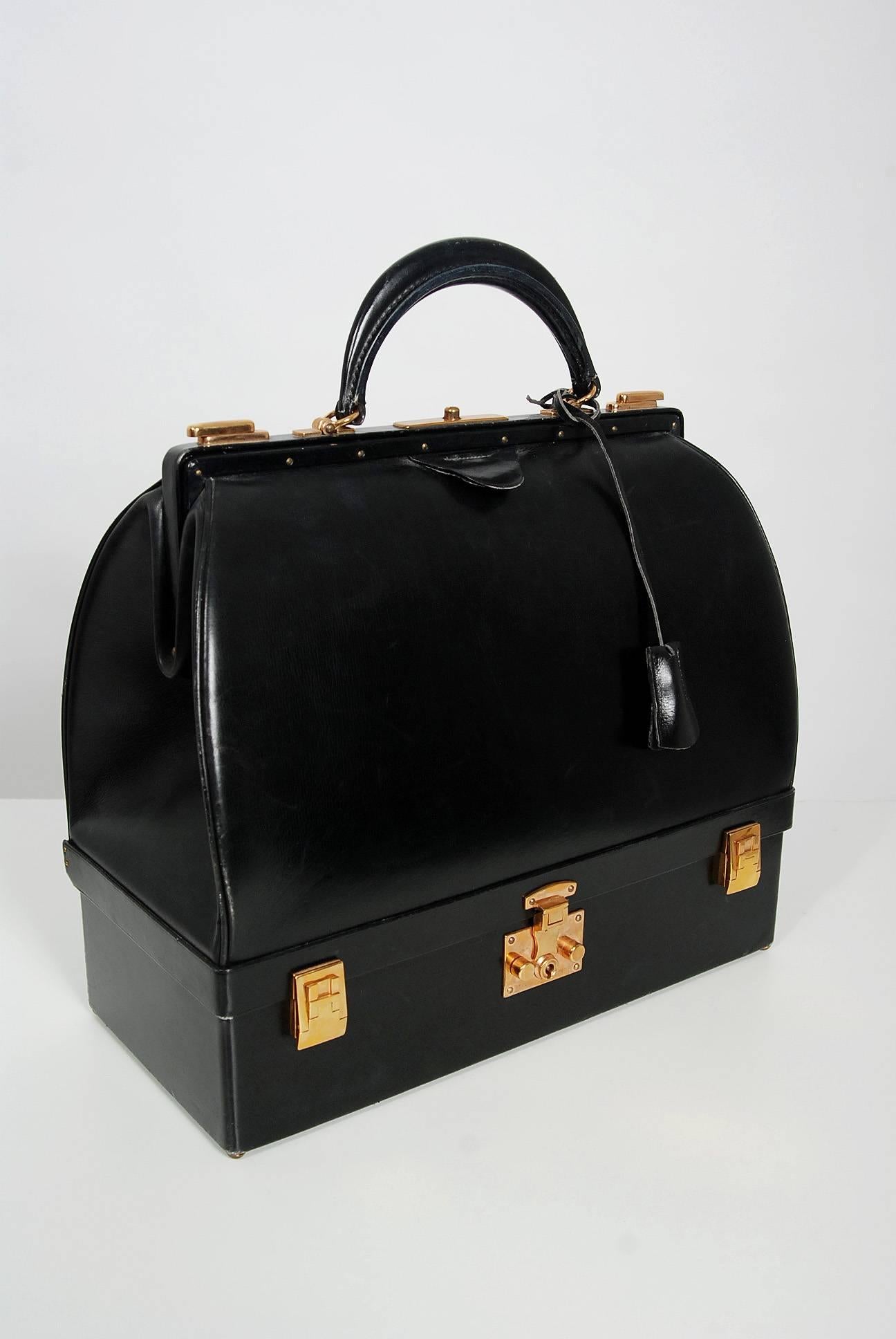 Hermès Paris has whispered the ultimate in luxury since 1837. This beautiful Sac Mallette, dating back to the mid 1970's, is a perfect example of this brand's elegant allure. The exterior features beautiful black box calfskin leather trimmed with