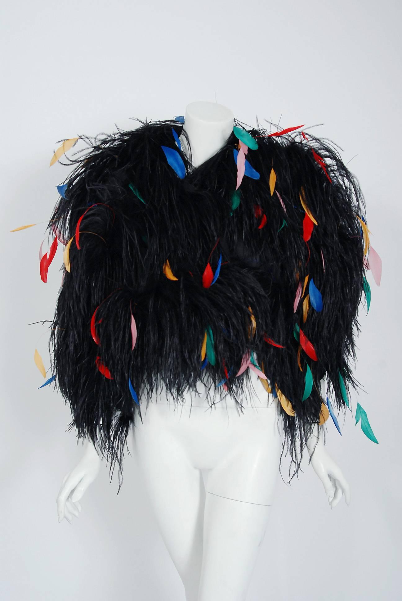 Breathtaking Bill Blass Couture rainbow feather bolero jacket dating back to his 1977 collection. Building upon the innovations of European designers such as Coco Chanel, Blass made clothes that allowed women a modern sense of ease. He made