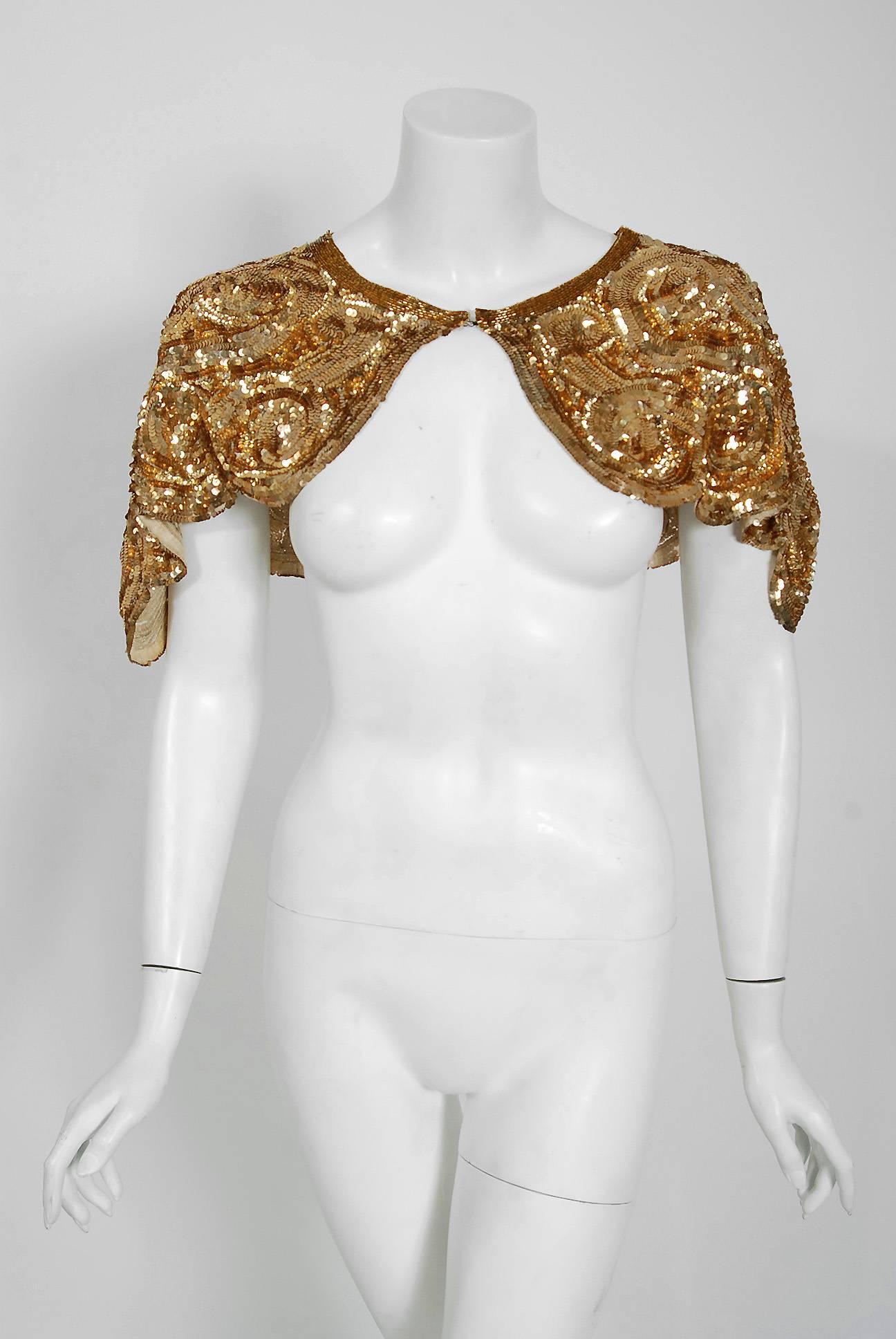 Breathtaking French Couture metallic-gold sequin scalloped capelet dating back to the mid 1920's. Evening capes from the Art-Deco era remain a perennial favorite, perhaps because no other period combined such opulence with youthful sass. The casual,