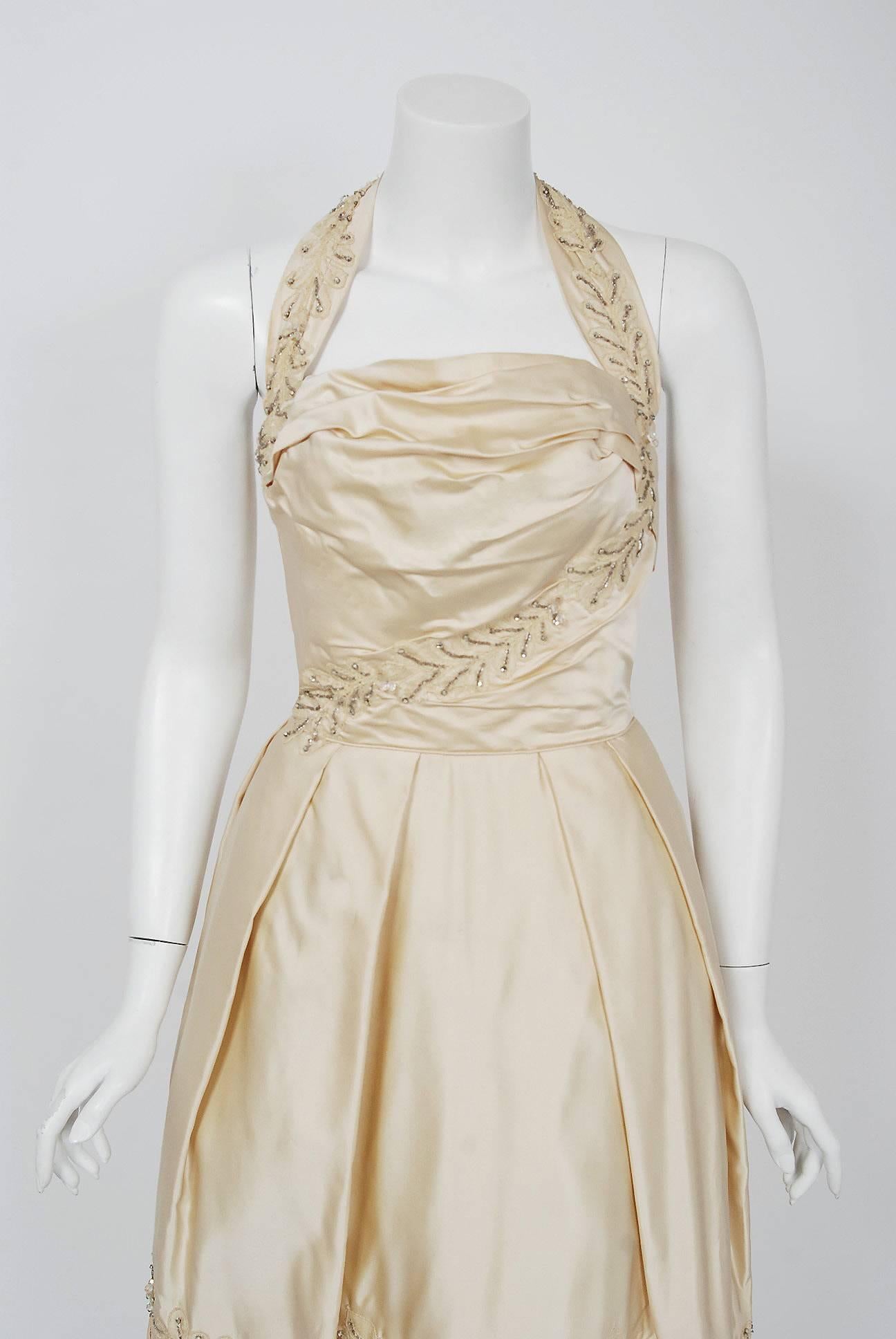 This is such a breathtaking and ethereal couture party dress from the iconic Ceil Chapman designer label. Perfect for any upcoming wedding; you can't help but feel feminine in this beauty. The garment is fashioned from stunning mid-weight ivory silk