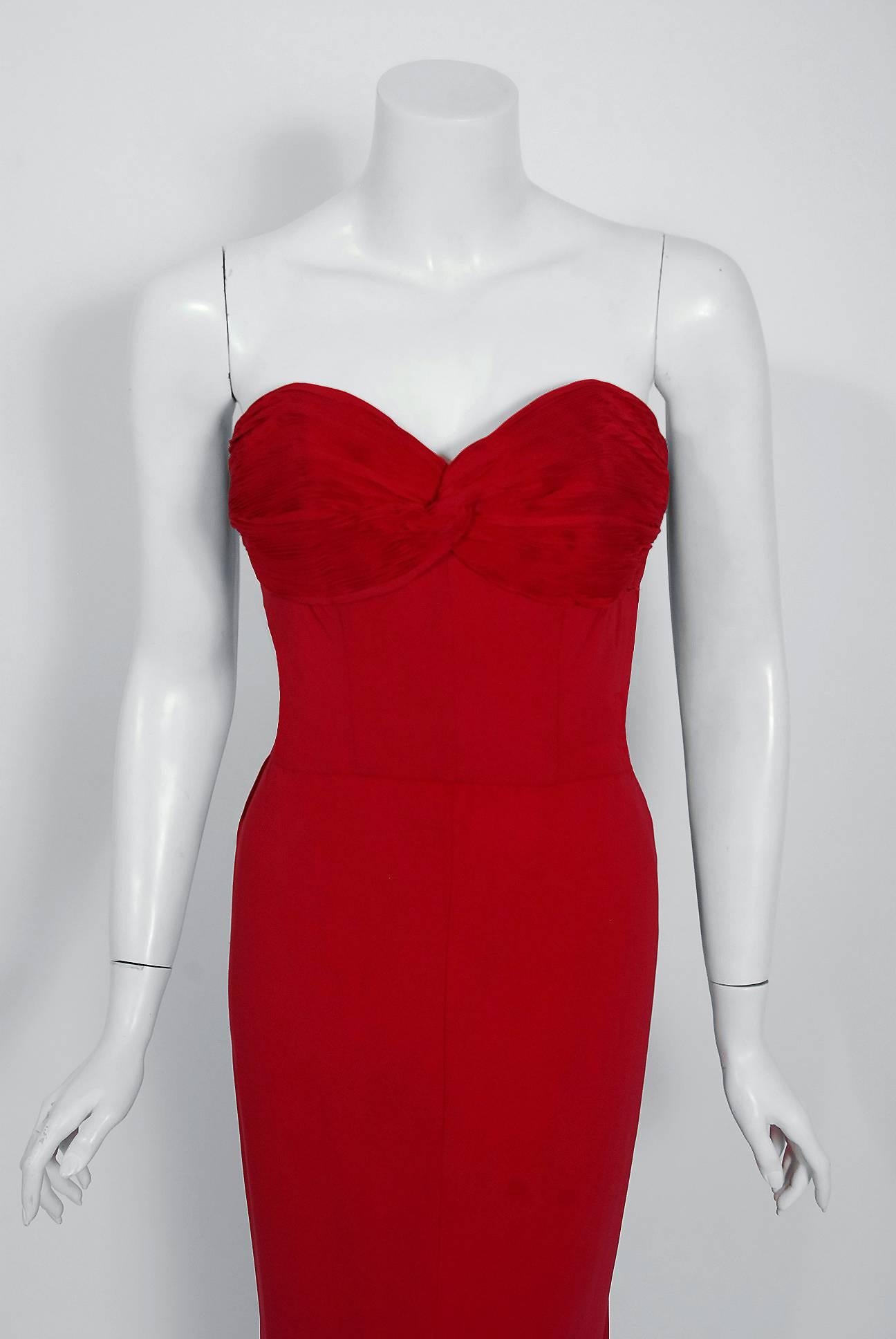 A seductive raspberry-red couture hourglass evening gown from the 1940's era of glamour. This stunning silk-rayon dress has so much detail, you can tell it was made with loving devotion. The bodice is hand-pleated and hand-stitched into place with a