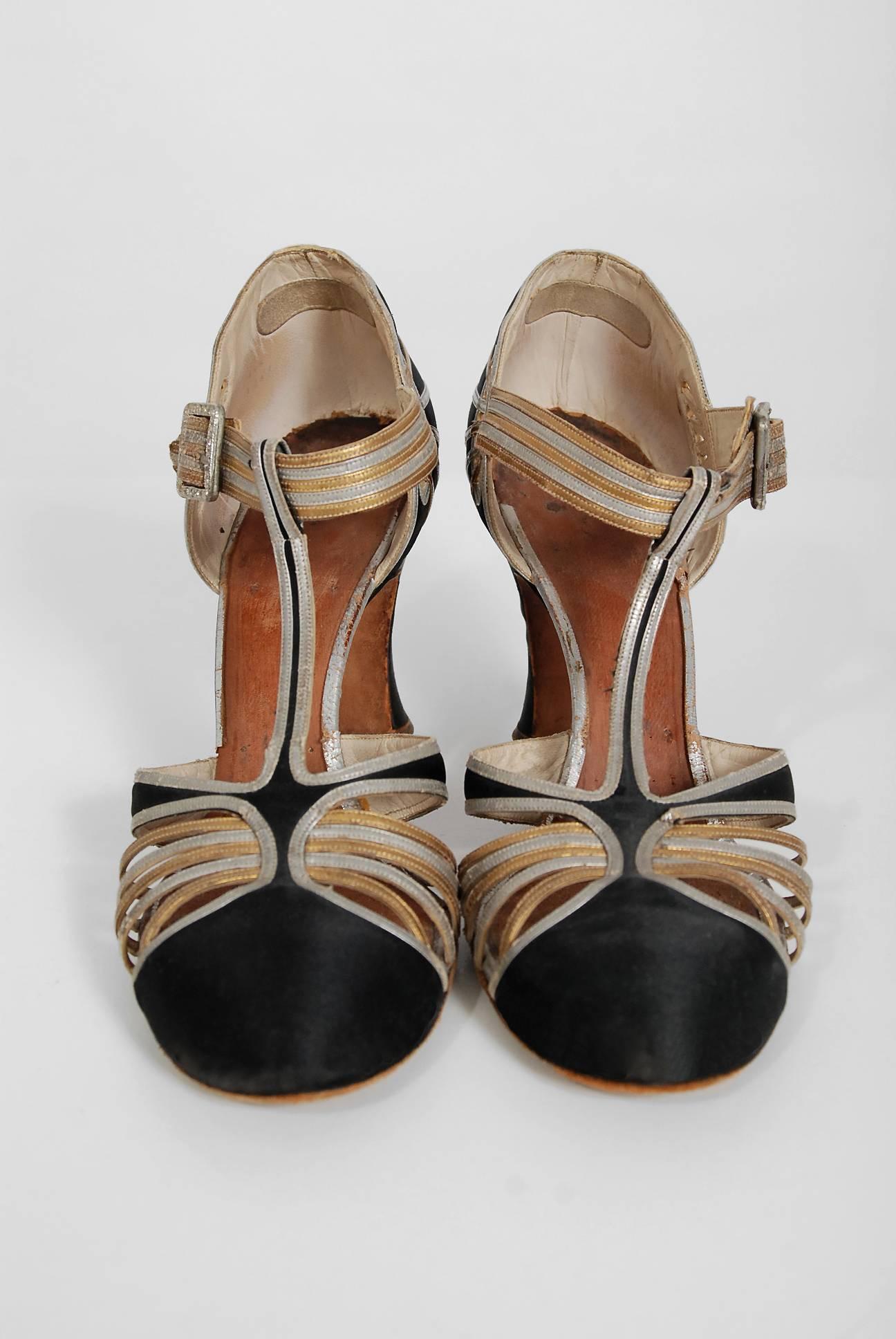 Stunning pair of authentic metallic leather and silk-satin flapper dance shoes dating back to the mid 1920's. The rising hemlines of this era focused attention on the exposed leg and foot. During this extravagant time, the demand for luxury shoes