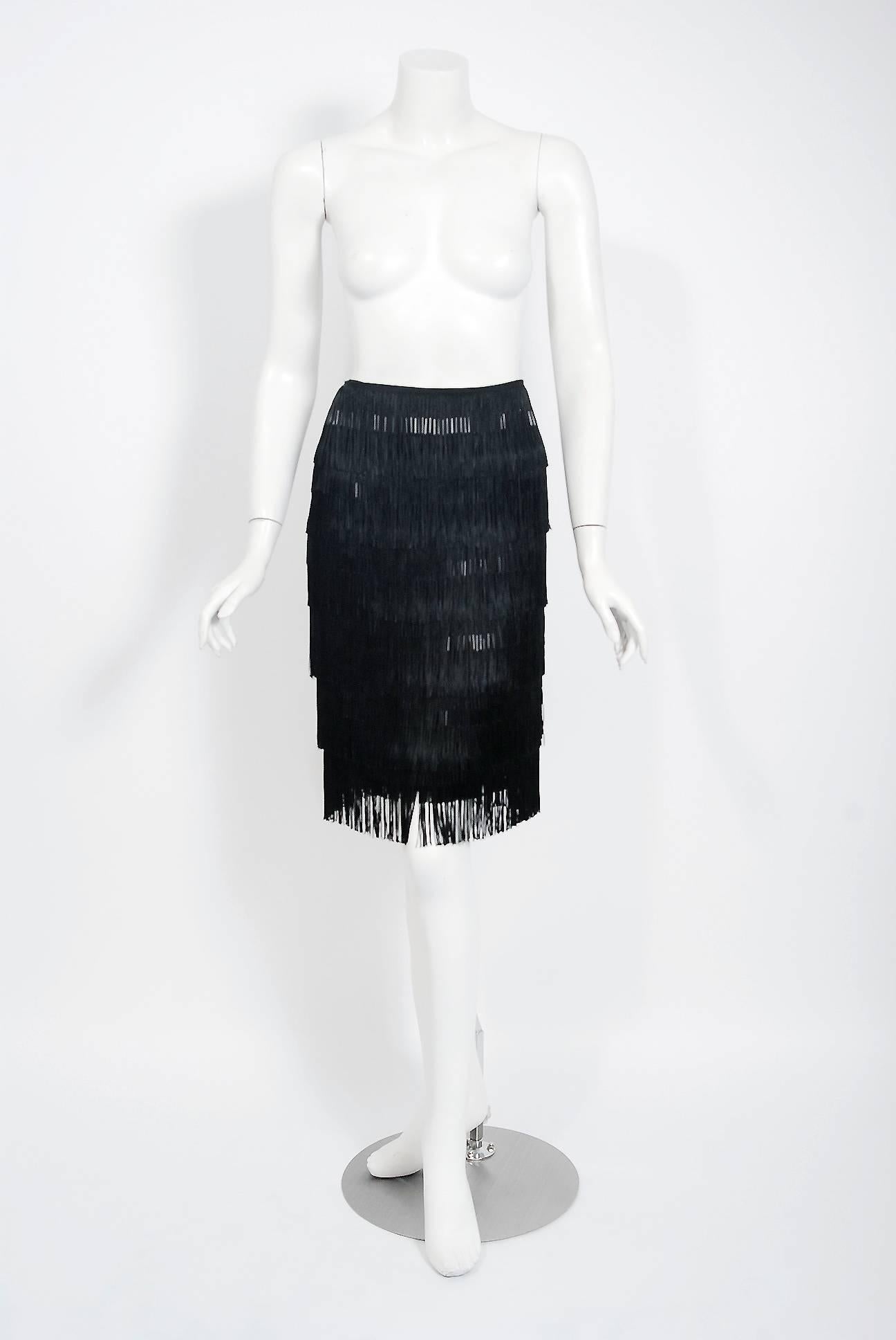 Breathtaking black beaded fringe skirt from the late and great Alexander Mcqueen. He was known for combining superb tailoring with a dramatic aesthetic inspired by various historical periods and sexually charged fetish wear. McQueen's thematic shows