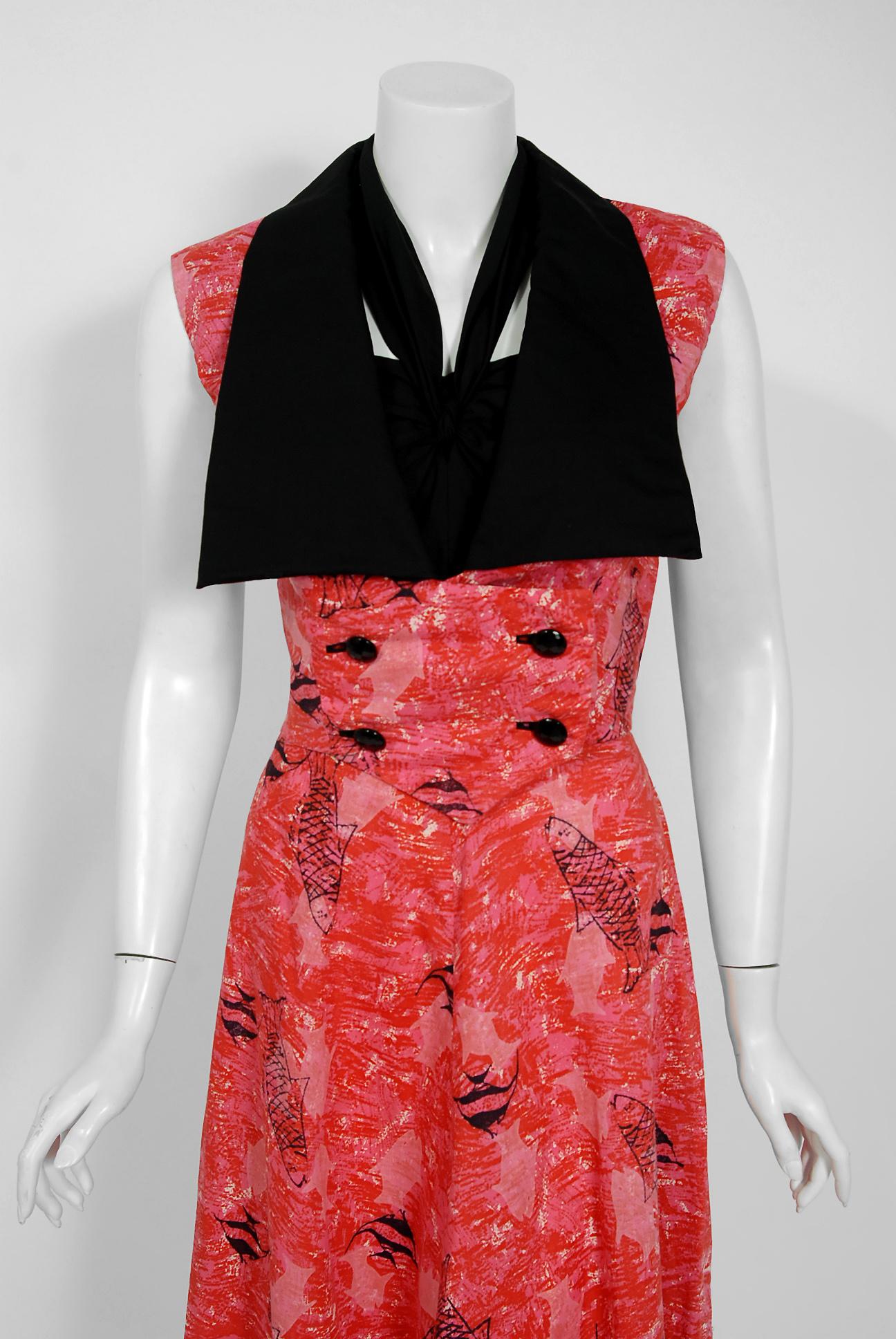 With its vibrant swimming fish novelty print and flawless styling, this Margaret Newman designer dress ensemble has the casual elegance the 1950's were known for. The fully-boned sweetheart plunge bodice with halter strap is very flattering and
