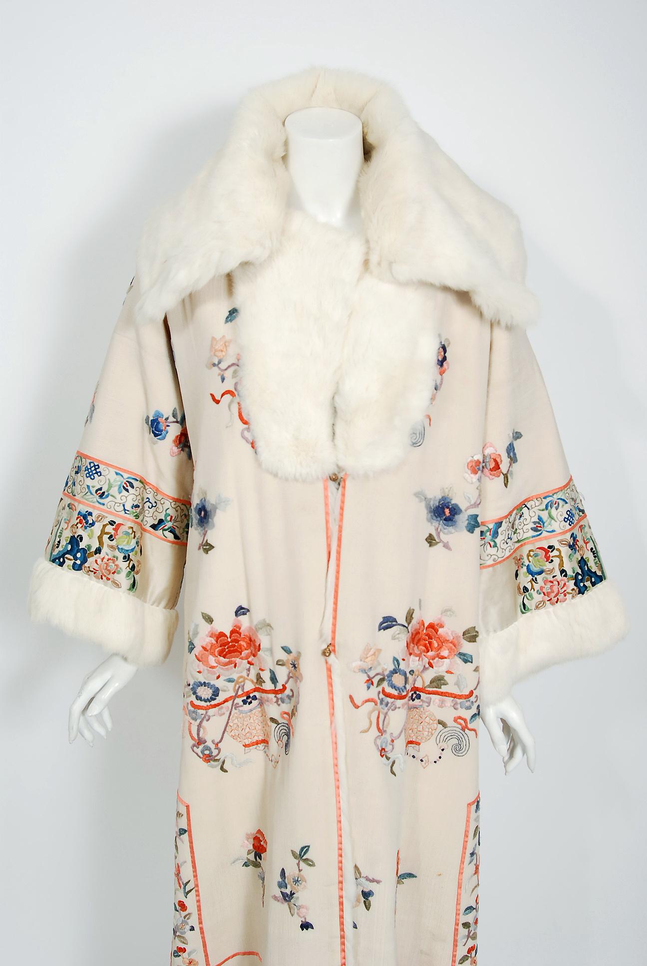 Breathtaking ivory silk-crepe embroidered Chinese couture reversible coat dating back to the mid 1920's. The colorful novelty scenic embroidery adds a perfect amount of drama to this luxury treasure. I love the oversized collar and brass ball