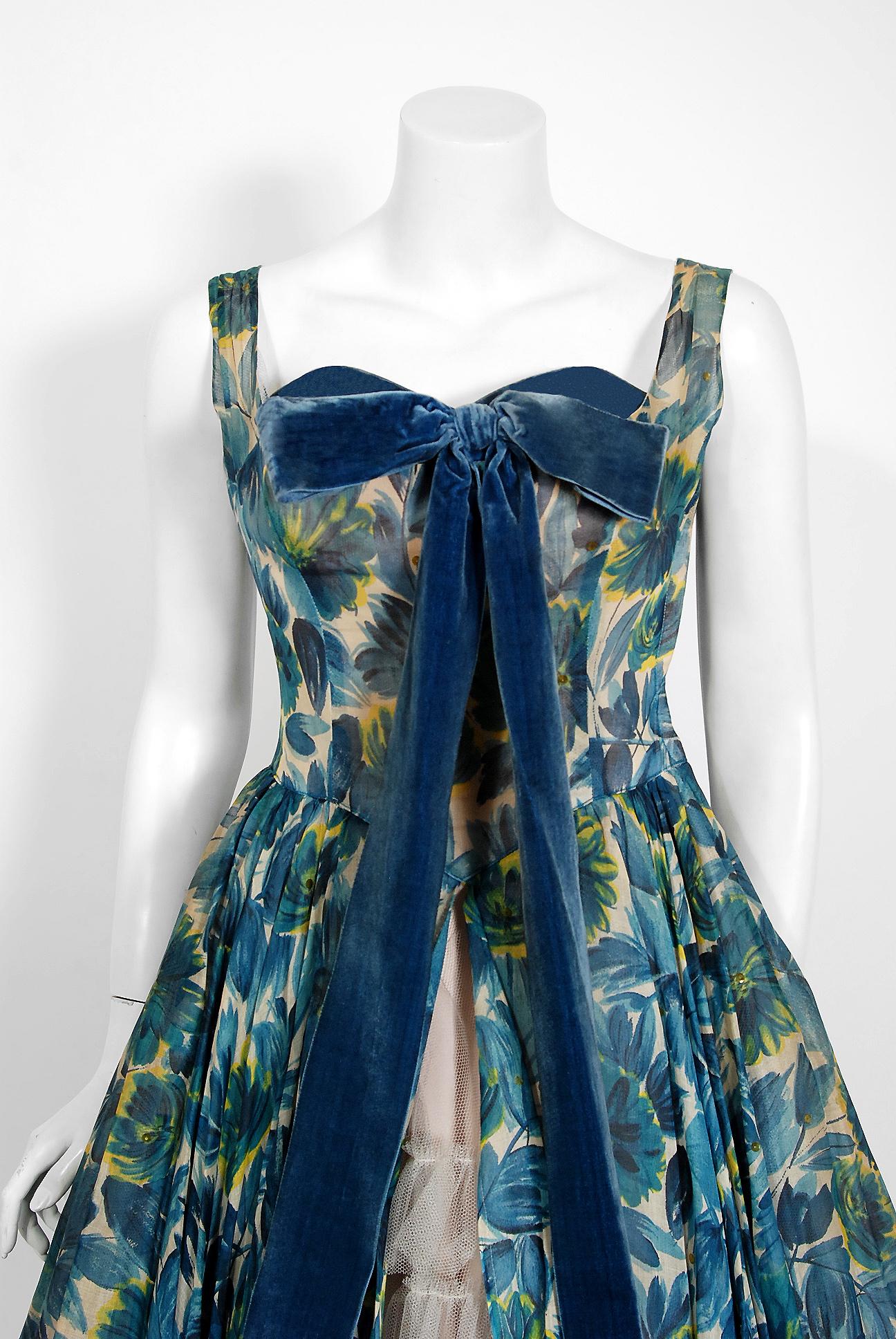 Fashioned from gorgeous blue floral-garden print organza, this 1950's Will Steinman creation has everything a woman wants. The sequin accents add the perfect amount of sparkle to the piece. The bodice has a gorgeous blue velvet boned sweetheart