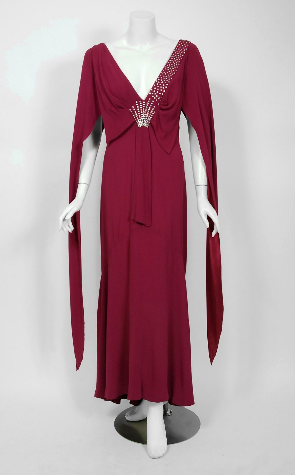 A breathtaking 1930's couture custom-made plum purple silk crepe gown from the Old Hollywood era of glamour. There is so much detail, you can tell this masterpiece was created with love and care. The bodice has a seductive sculpted plunge with