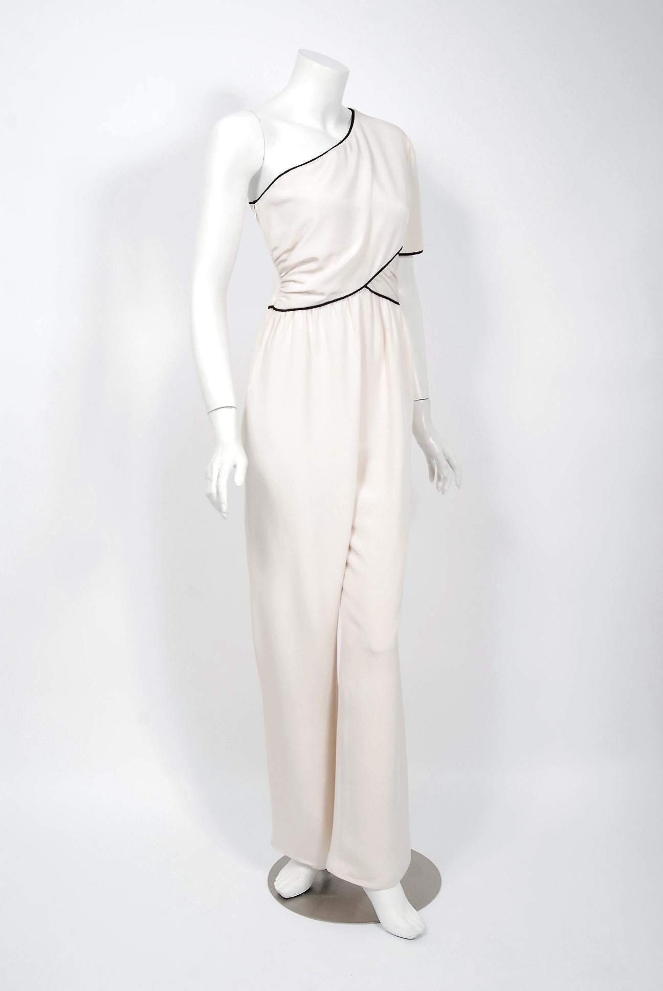 Gorgeous Bill Blass Couture ivory-creme silk jumpsuit dating back to his 1979 collection. Building upon the innovations of European designers such as Coco Chanel, Blass made clothes that allowed women a modern sense of ease. He made glamorous