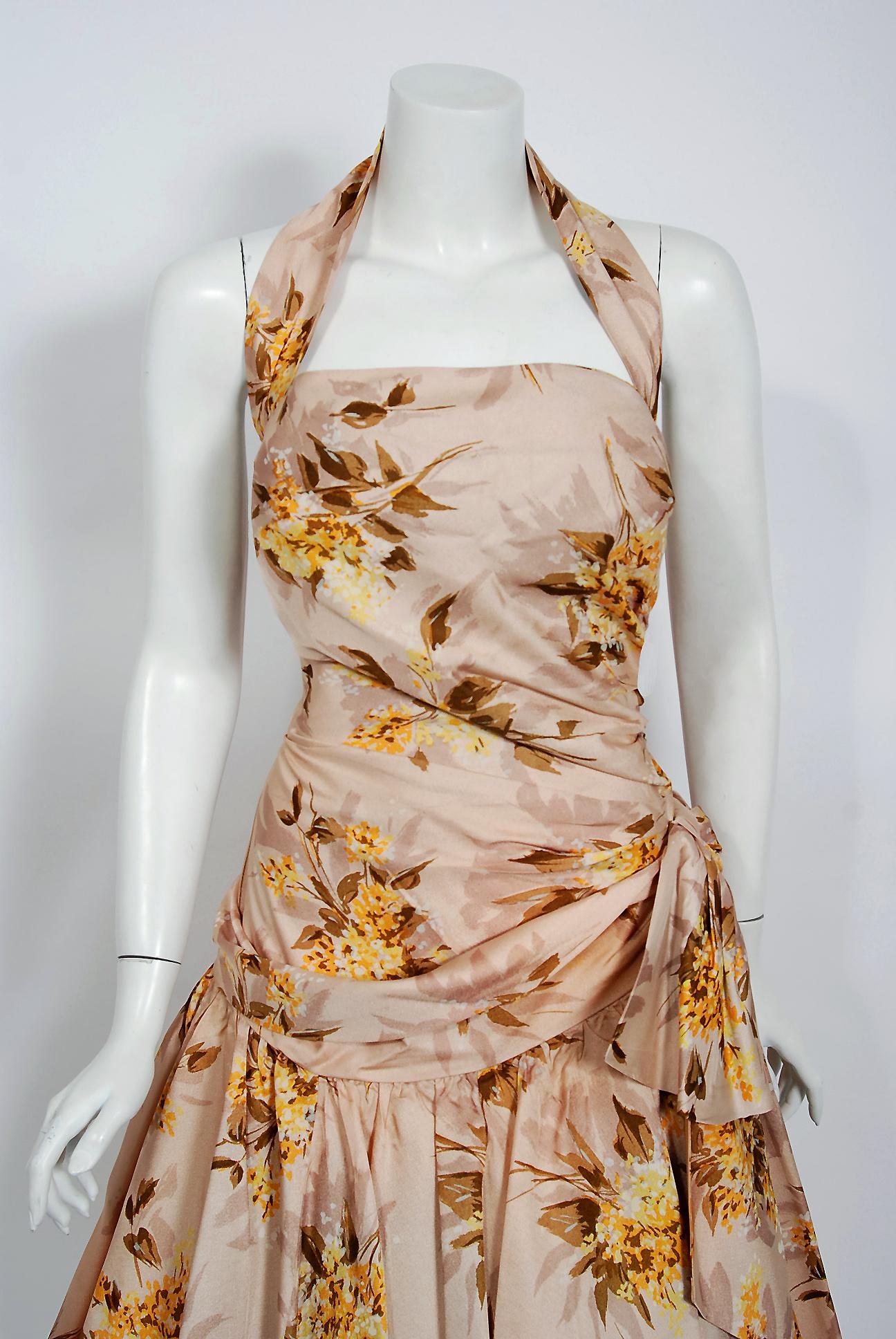 This gorgeous 1950's marigold floral blush garden print rayon ensemble is the perfect addition to any vintage wardrobe. So Christian Dior! The bodice has an alluring wide-strap halter with optional 3/4-length sleeve cropped bolero. The ruched