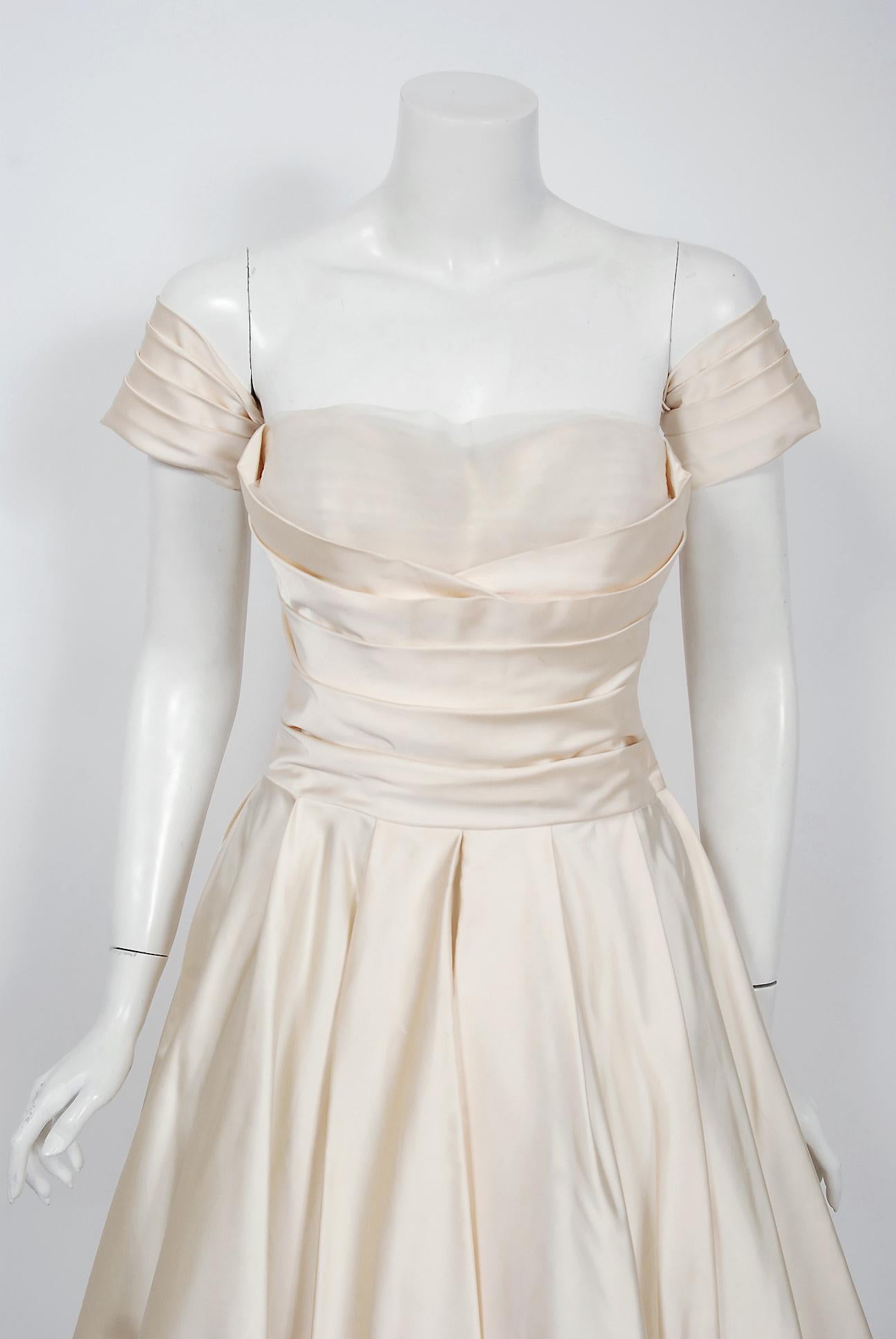 A magnificent 1950's creation by the iconic dress designer Fred Perlberg. It's hard to believe she has never been worn and still has the original Bonwit Teller store tags! This gorgeous garment is fashioned from mid-weight lined satin in the most