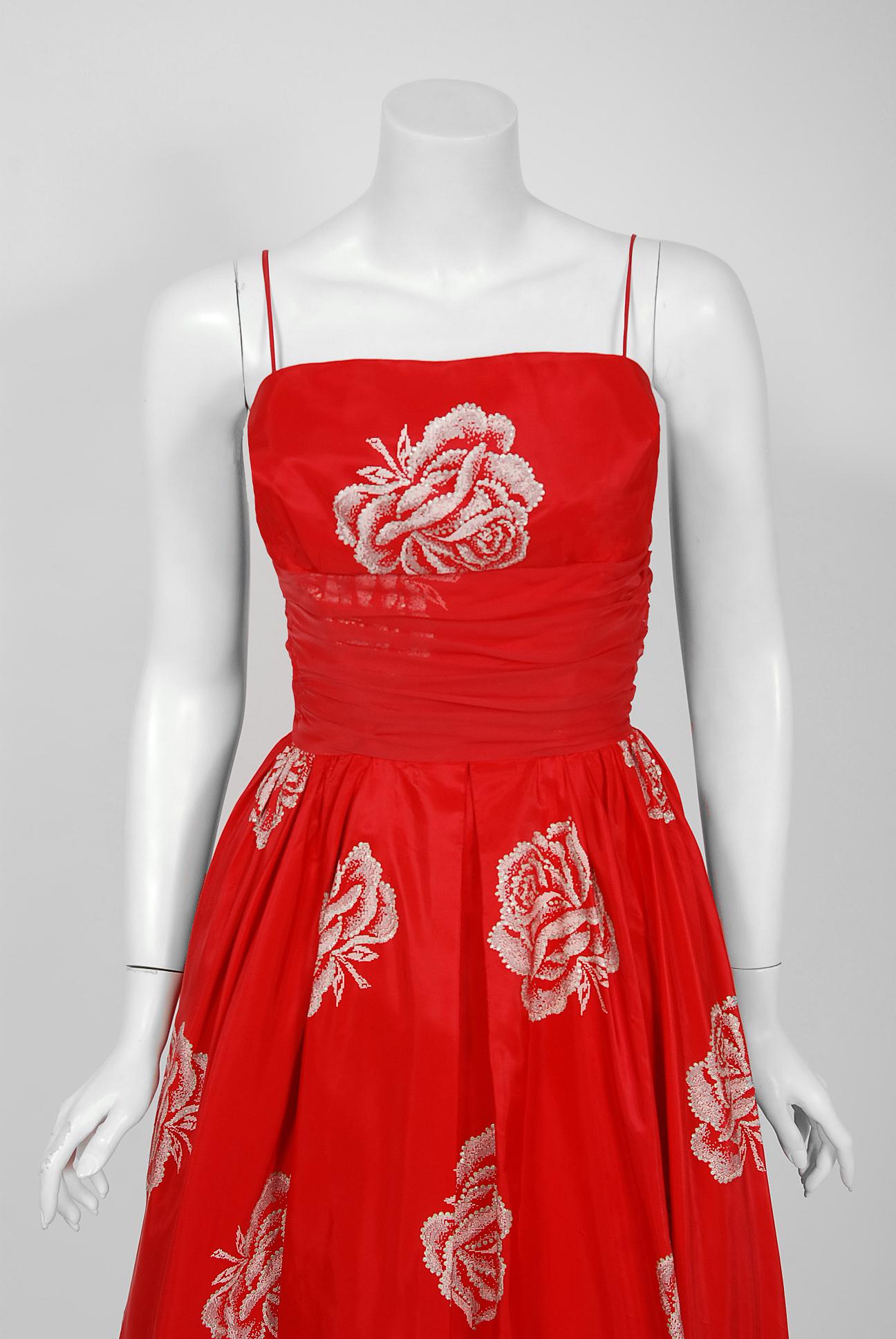 With its shimmering large-scale rose floral print and flawless New Look silhouette, this Lorrie Deb designer party dress has the casual elegance the 1950's were known for. The fabric alone is exquisite; metallic glitter roses on ruby-red 