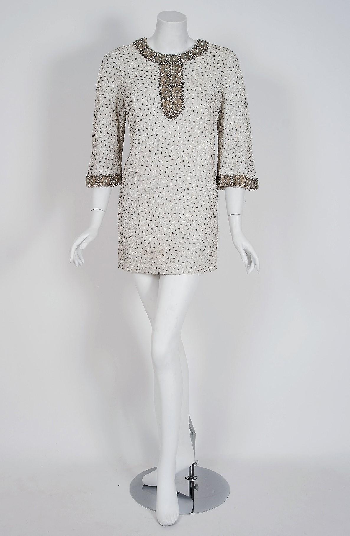 A truly wonderful and unusual 1960's cocktail dress by Nettie Milgrim. Nettie was the sister of late fashion designer Sally Milgrim who dressed celebrities and socialites; most notably Eleanor Roosevelt's inaugural gown. The Milgrim family also had