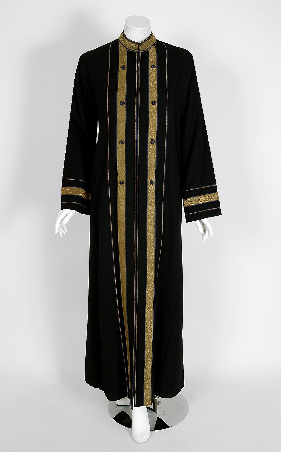 Gorgeous Thea Porter designer full length coat fashioned in the most beautiful black cotton-twill and textured metallic gold-lame dating back to the early 1970's. I love the nehru collar and over-sized side pockets. The open front silhouette allows