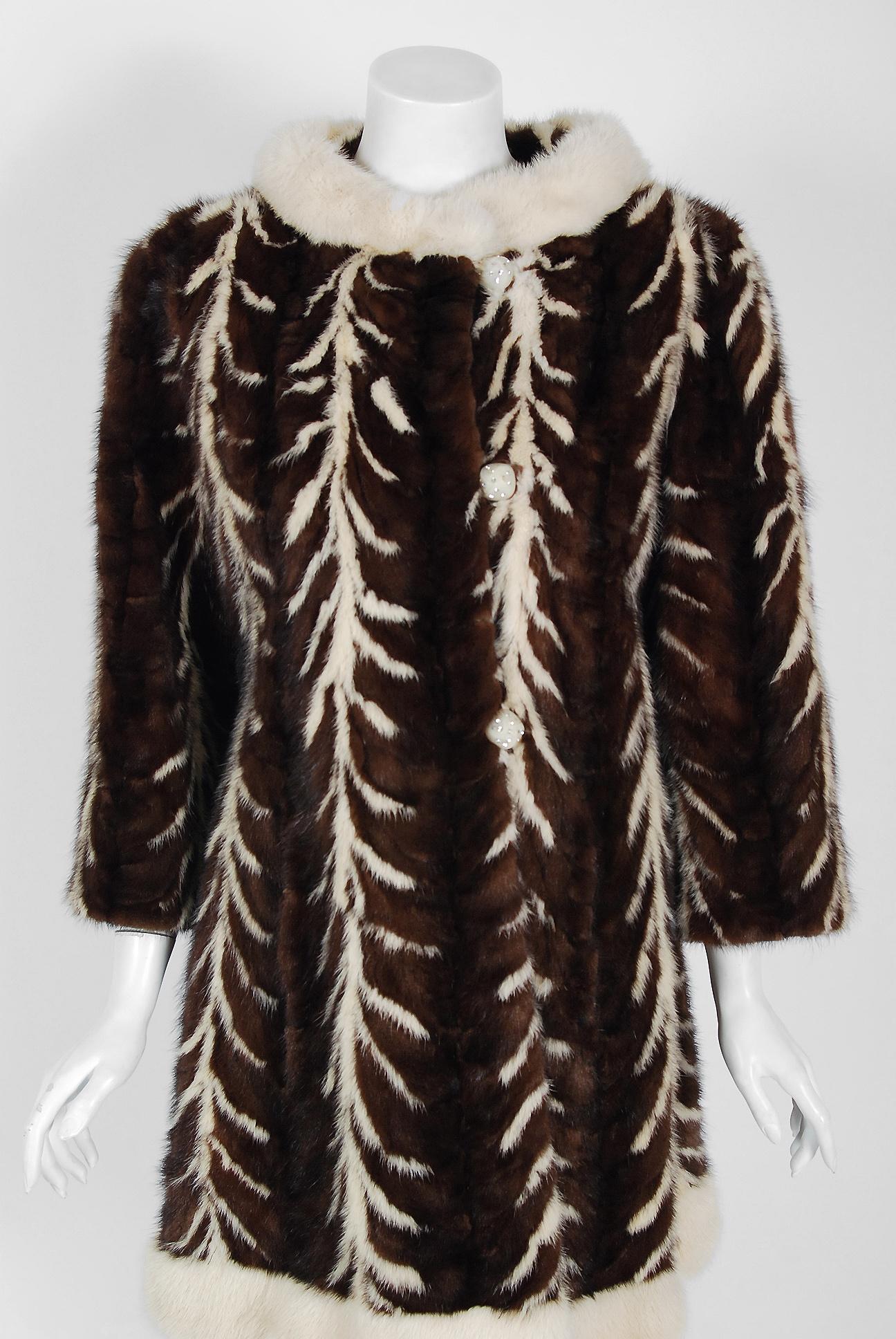 A breathtaking late 1960's ivory and chocolate-brown colored genuine mink fur from the exclusive high-end couture boutique Arnold Constable. This tailored designer coat will make any woman shine during cold winter months. It is easy to see the level