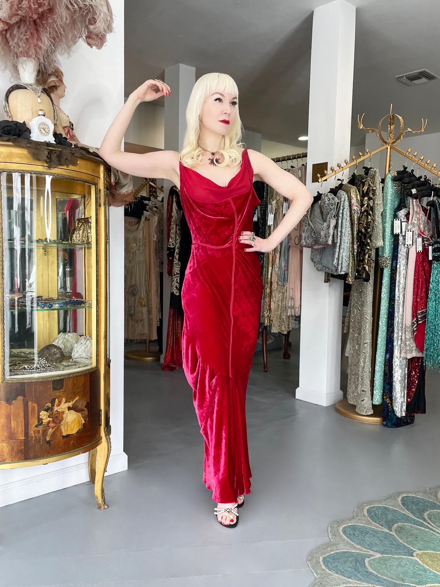 A super seductive and highly coveted Christian Dior ruby red logo patterned stretch velvet bias-cut gown dating back to John Galliano's epic 2006 fall/winter runway collection. John Galliano is widely considered one of the most innovative and