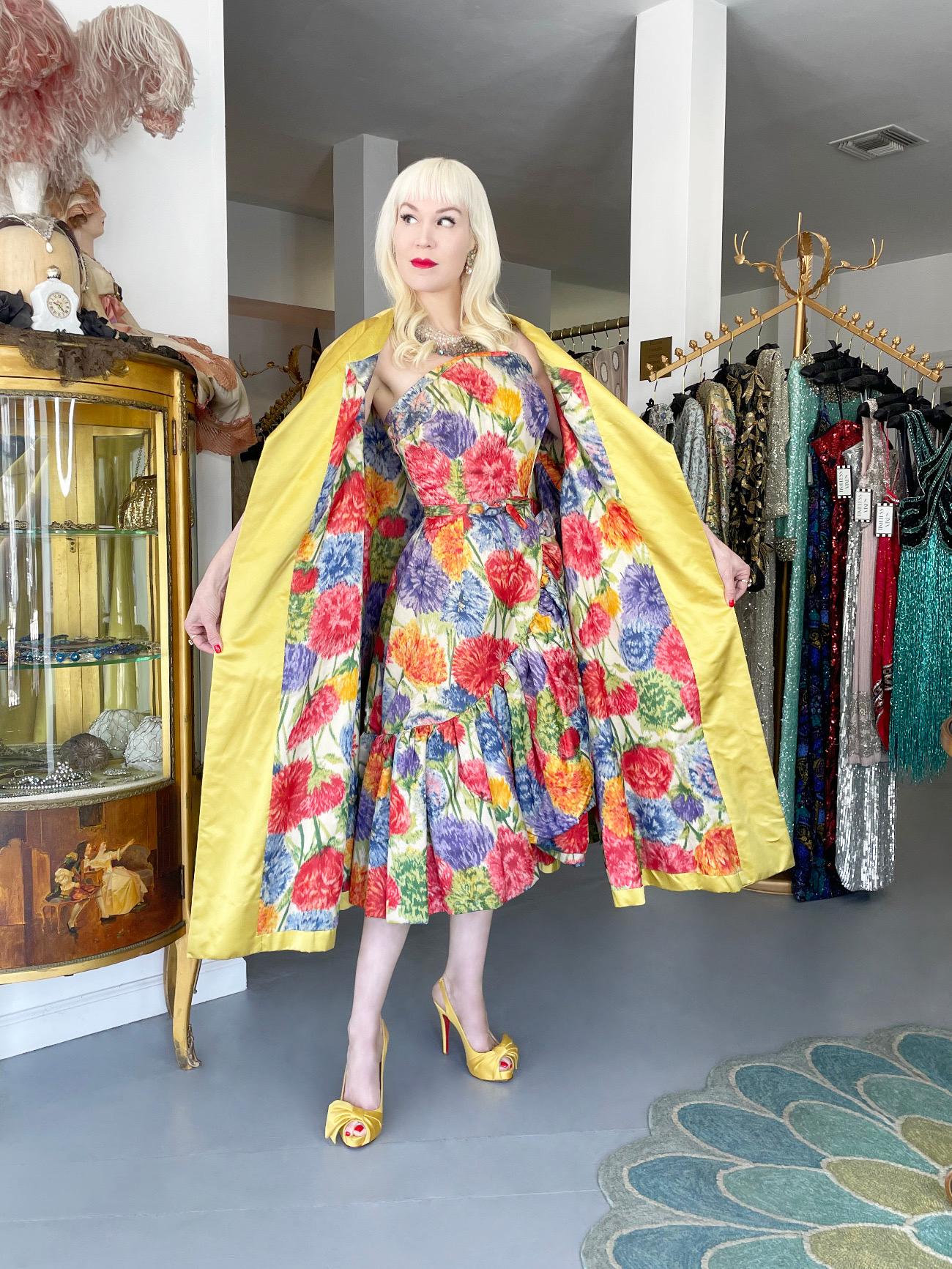 An absolutely gorgeous and ultra rare Arnold Scaasi custom couture colorful watercolor floral print silk dress and matching golden yellow satin jacket dating back to his 1958 spring/summer collection. Scaasi started his career designing for Charles