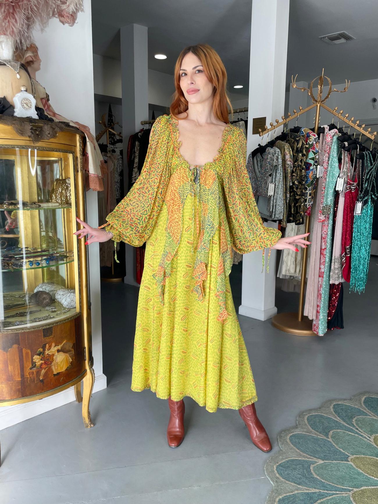 A highly coveted and extremely special Ossie Clark for Quorum Ceilia Birtwell yellow squiggle print silk chiffon cut-out sleeve bohemian dress dating back to 1971. They had a magical collaboration! Birtwell’s vibrant prints, combined with Clark's
