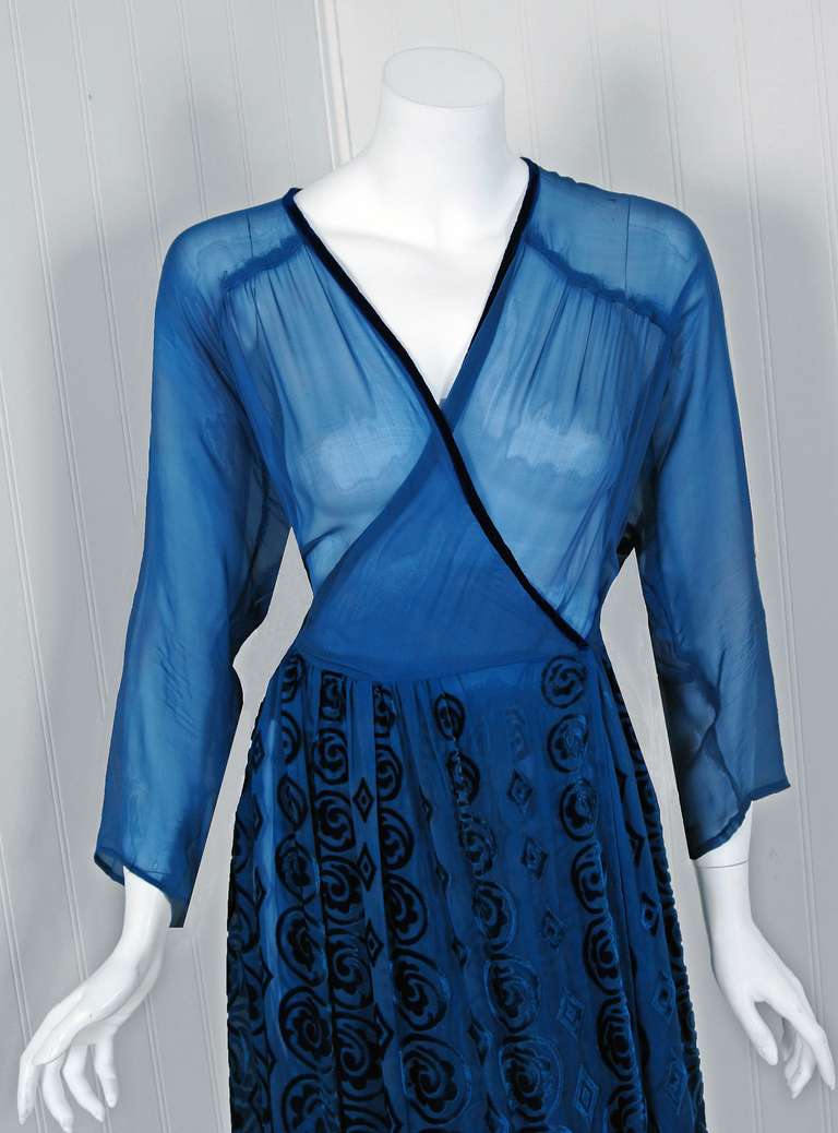 Incredible late 1930's gown made entirely of a vivid sapphire-blue velvet flocked silk-chiffon. I love the semi-sheer tone which allows one to change the depth of tone and look by what you choose to wear underneath. The skirt flocking in particular